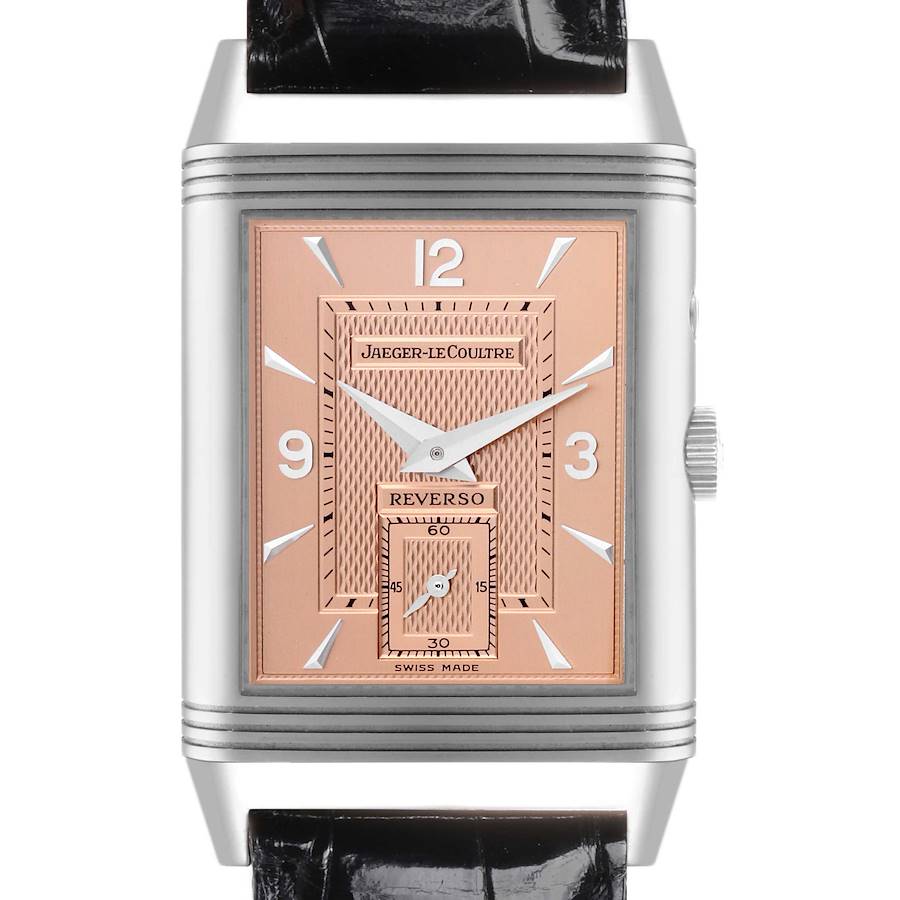 The Jaeger-LeCoultre Reverso watch is shown from a front angle, highlighting its rose gold dial, numerals, and black leather strap.