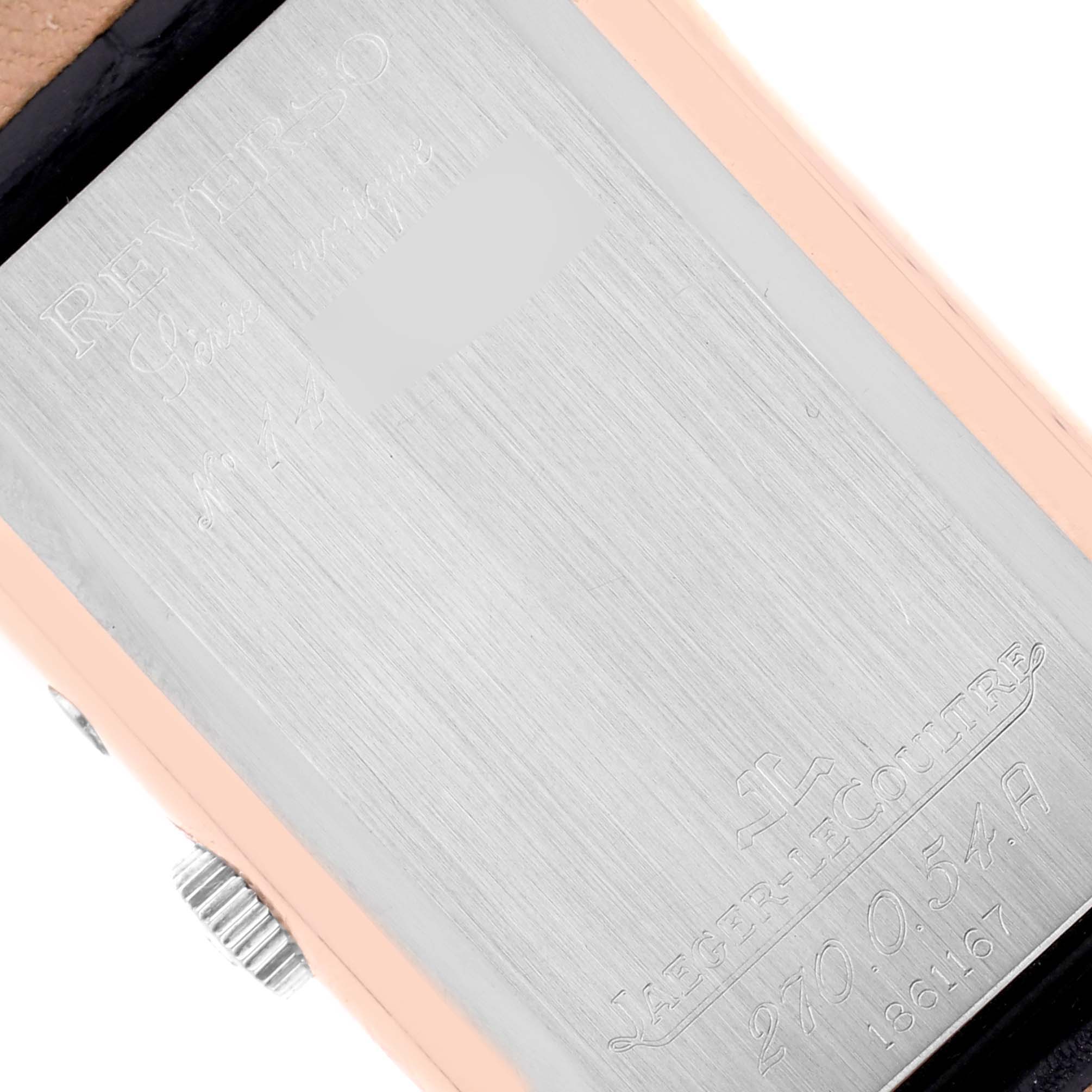 The image shows the back case of a Jaeger-LeCoultre Reverso watch, highlighting the brand engraving.