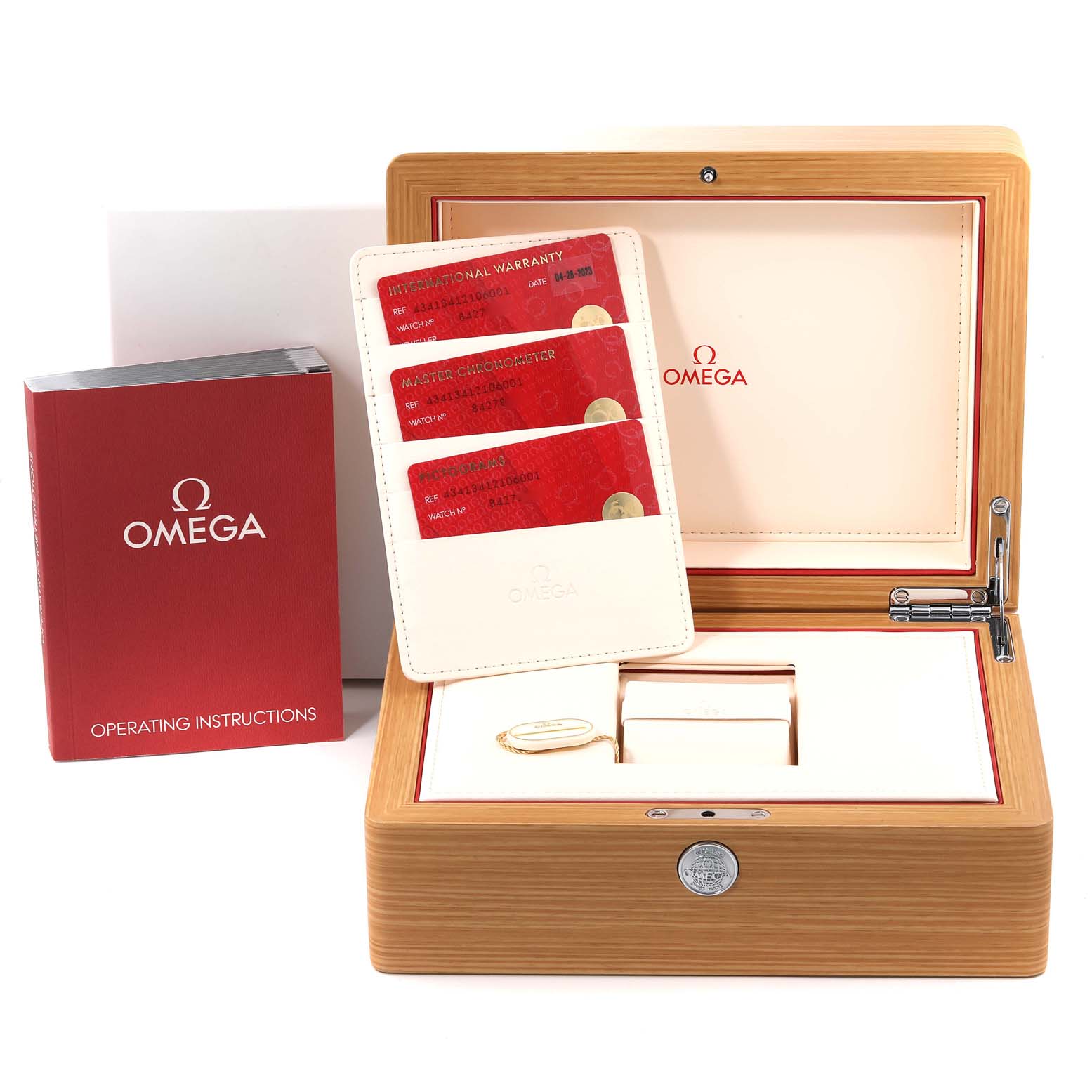 The image shows the packaging and accessories for an Omega De Ville 434.13.41.21.06.001 Men's Stainless Steel Grey Dial 434.13.41.21.06.001 Men's Stainless Steel Grey Dial watch, including a wooden box, cards, and an instruction manual.
