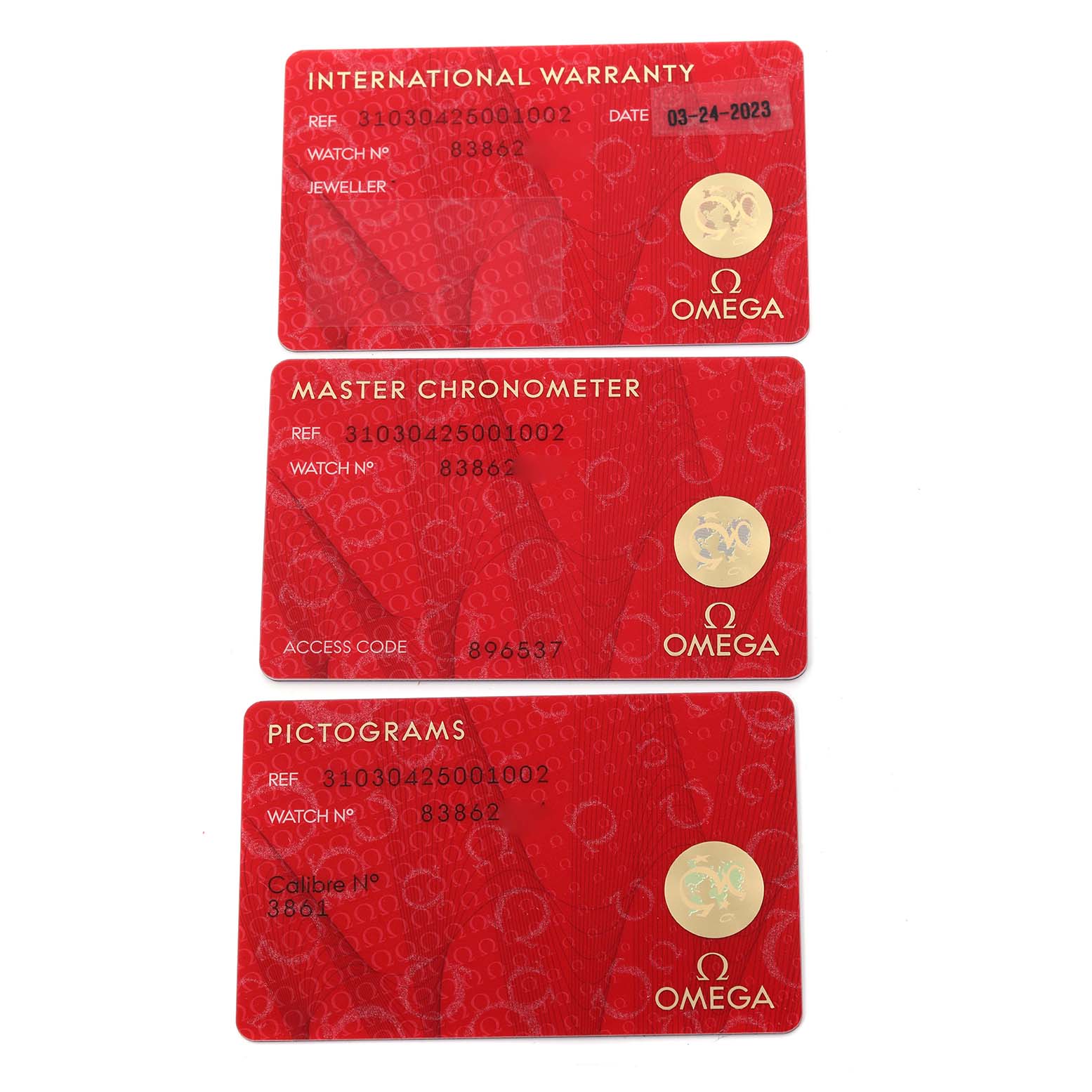 The image shows three red Omega cards for the Speedmaster: International Warranty, Master Chronometer, and Pictograms.