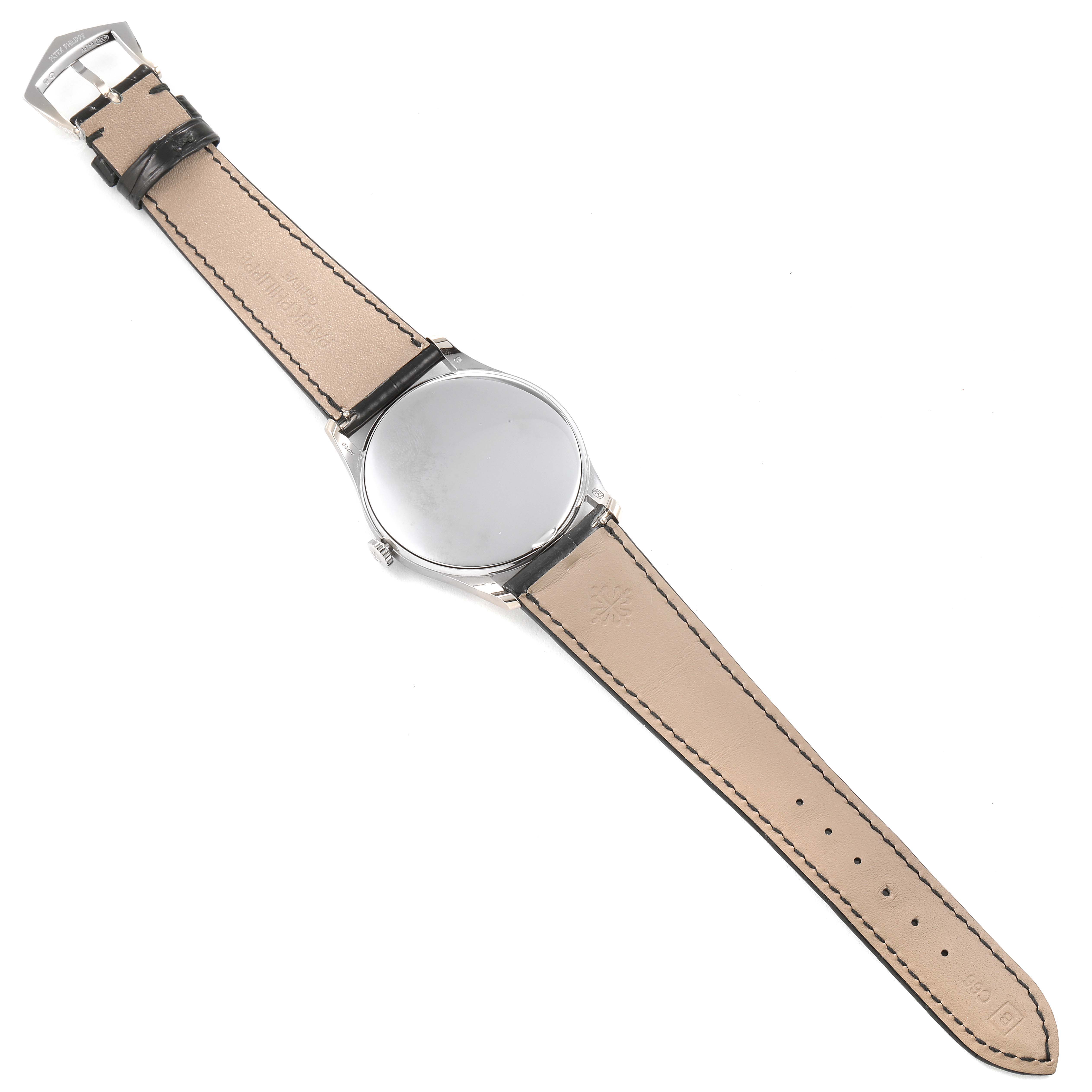 The image shows the back view of a Patek Philippe Calatrava 5196G Men's White Gold Silver Dial 5196G Men's White Gold Silver Dial watch with its entire leather strap and buckle visible.