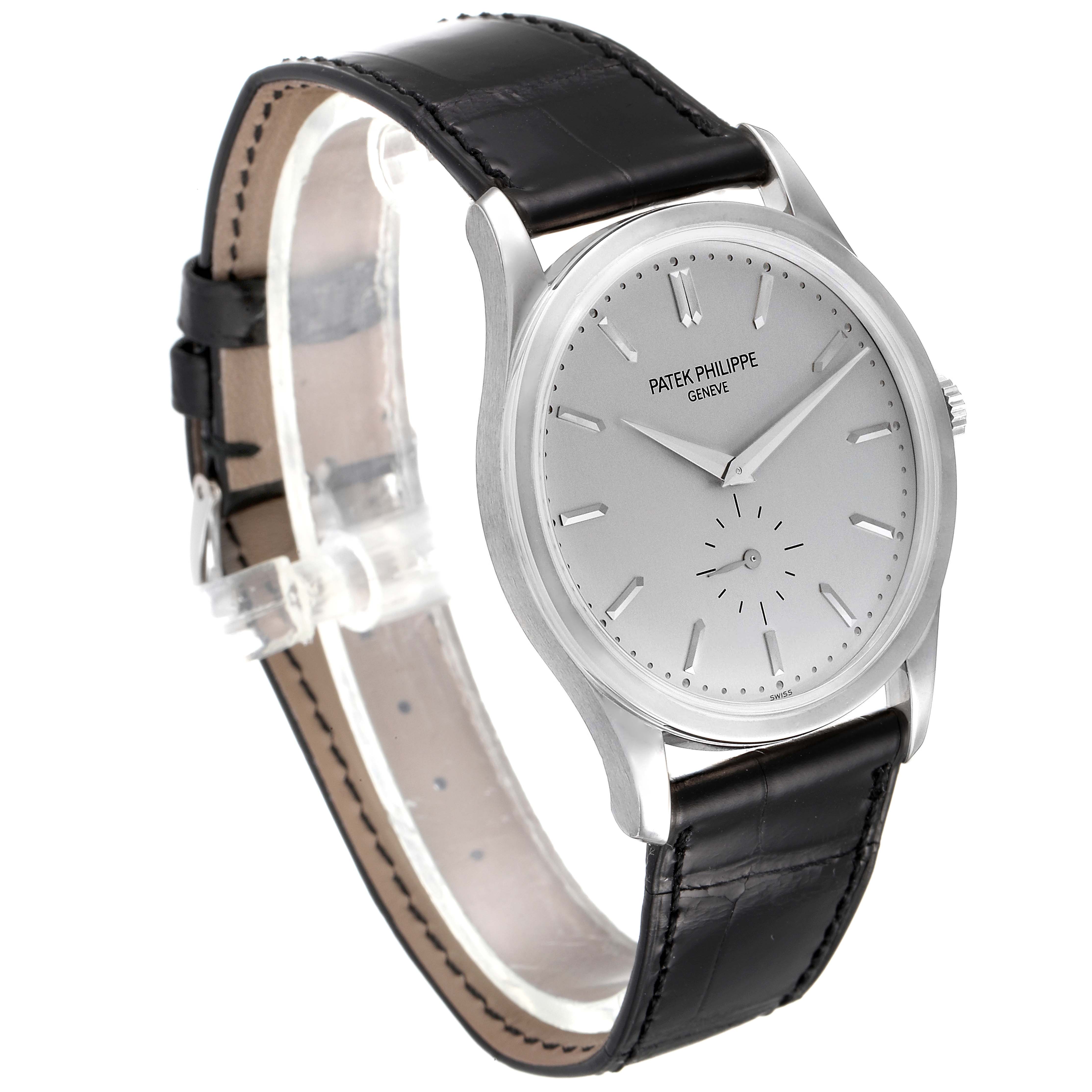 The Patek Philippe Calatrava 5196G Men's White Gold Silver Dial 5196G Men's White Gold Silver Dial watch is shown from a front and side angle, highlighting its face, case, and leather strap.