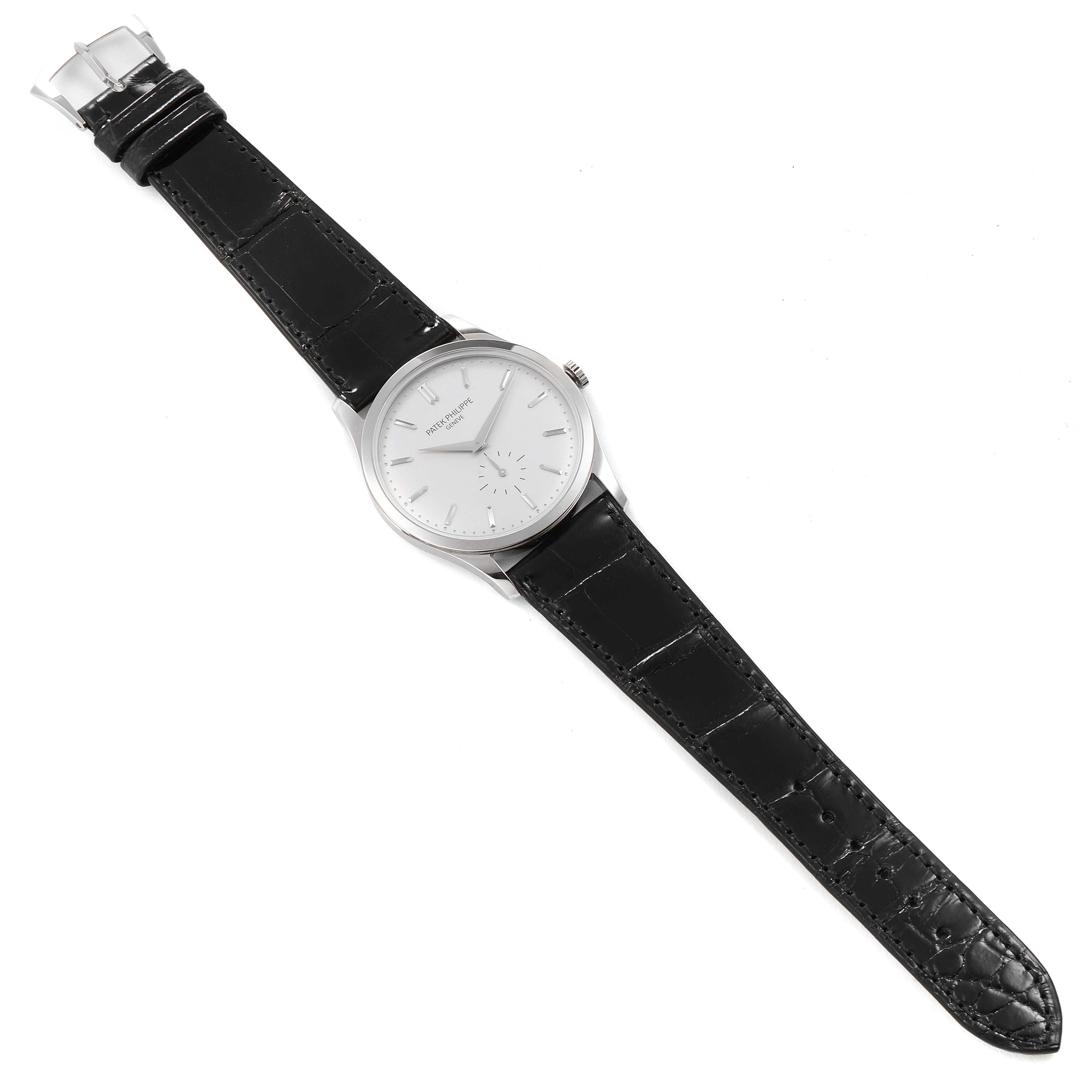 The image shows a top-down view of a Patek Philippe Calatrava 5196G Men's White Gold Silver Dial 5196G Men's White Gold Silver Dial watch with a black leather strap and silver dial.