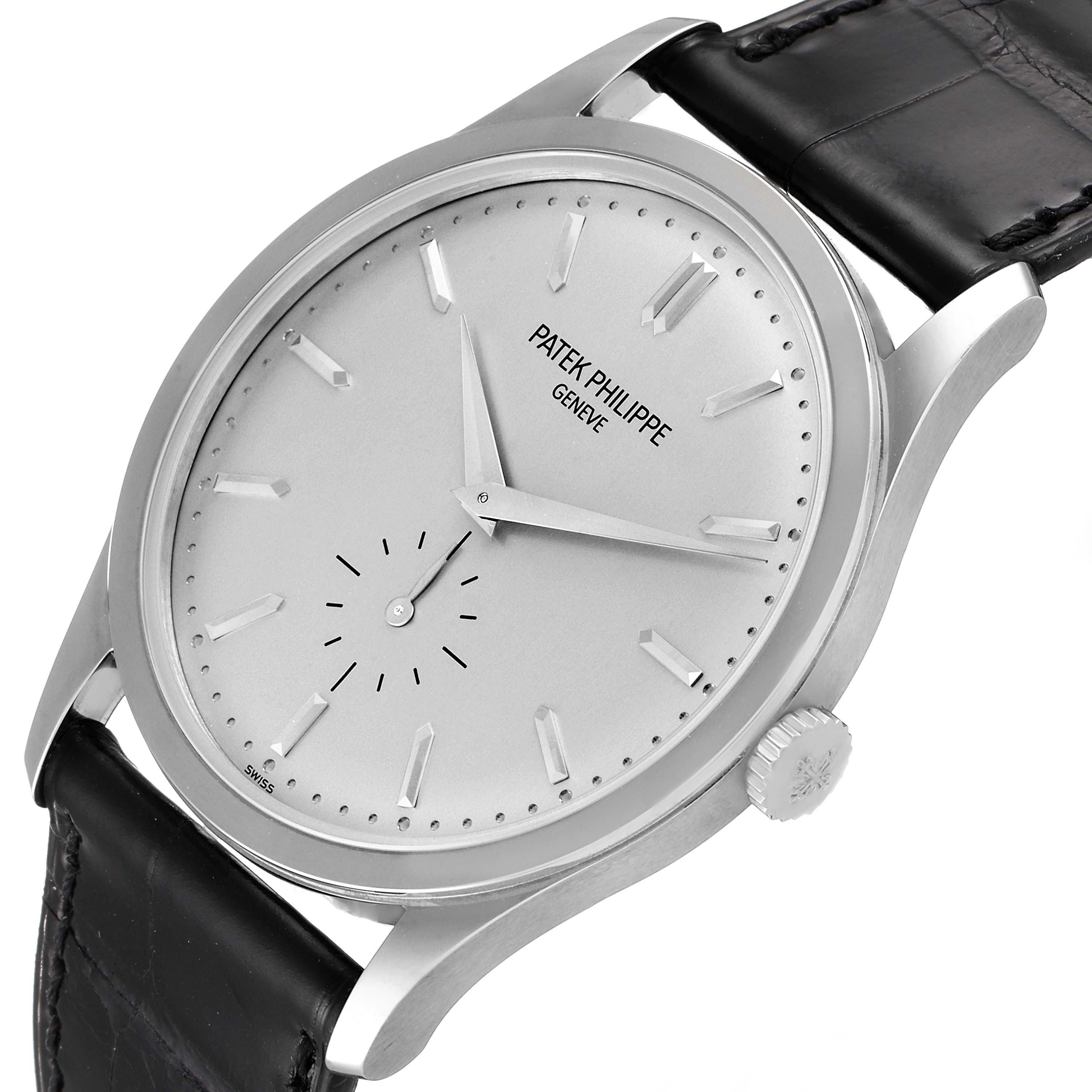 The Patek Philippe Calatrava 5196G Men's White Gold Silver Dial 5196G Men's White Gold Silver Dial watch is shown at an angled close-up, highlighting its dial, hands, crown, and leather strap.