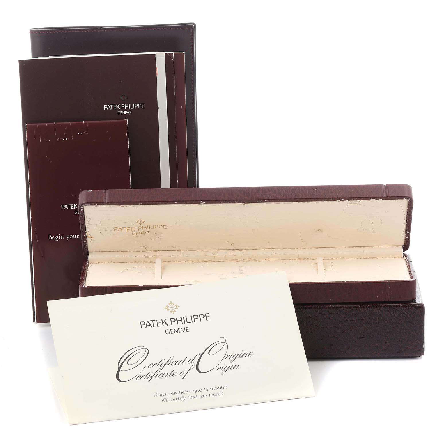 The image shows Patek Philippe Calatrava 5120G-001 Men's White Gold White Dial 5120G-001 Men's White Gold White Dial watch accessories, including a box, booklet, and certificate of origin, from a frontal angle.