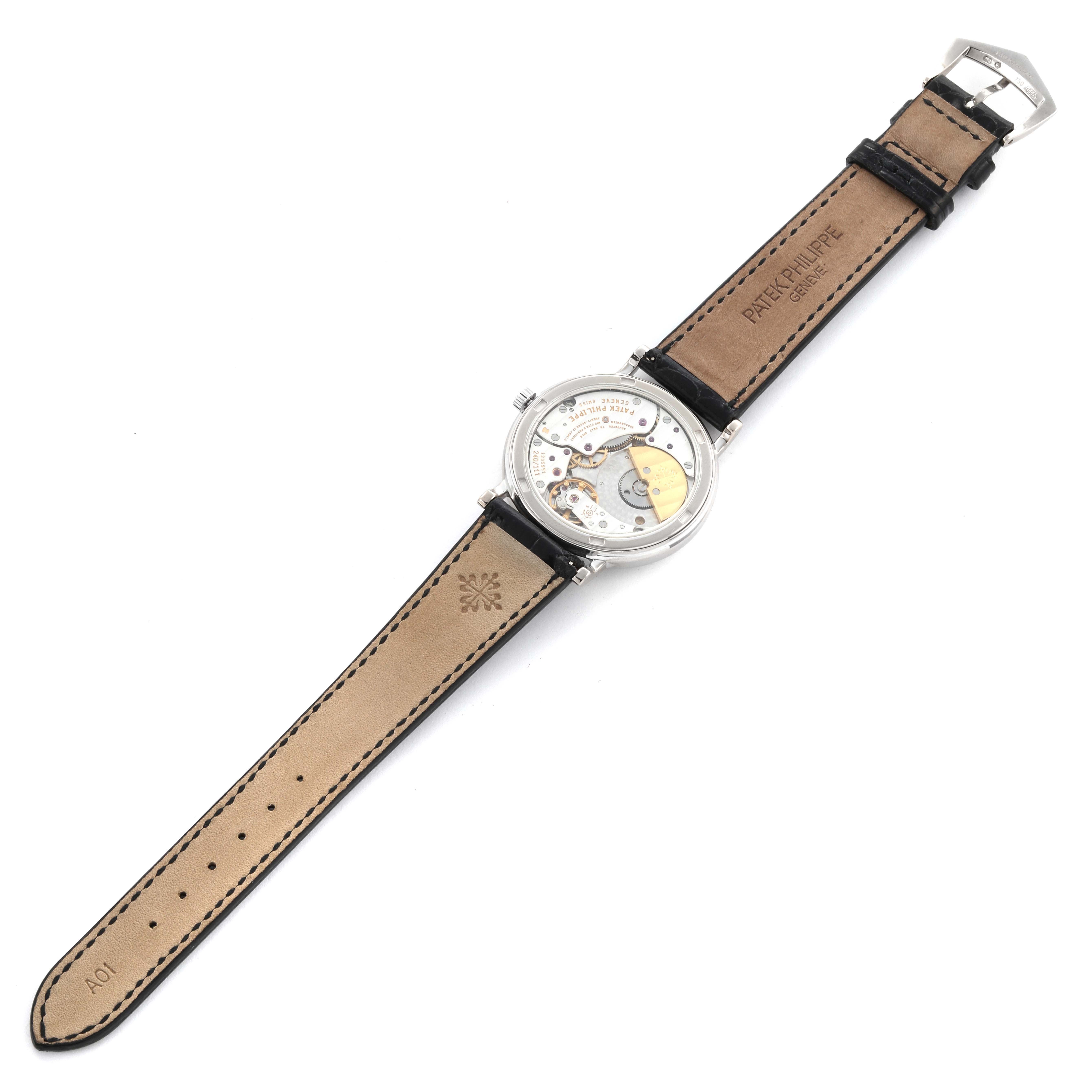 The image shows a Patek Philippe Calatrava 5120G-001 Men's White Gold White Dial 5120G-001 Men's White Gold White Dial watch from the back, highlighting the movement and leather strap details.