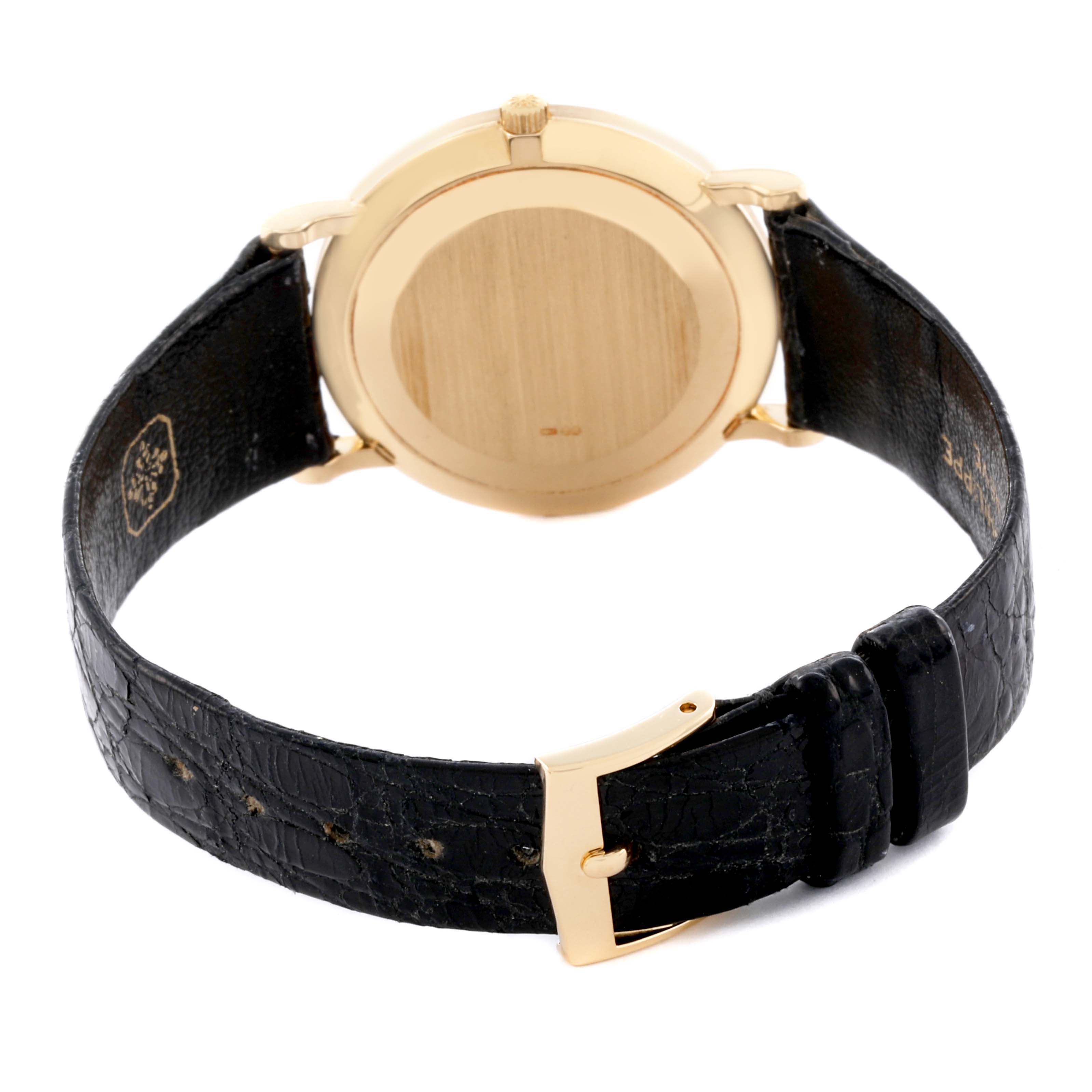 The image shows the back of a Patek Philippe Calatrava 3919J Men's Yellow Gold White Dial 3919J Men's Yellow Gold White Dial watch, highlighting the gold case and black leather strap with buckle.