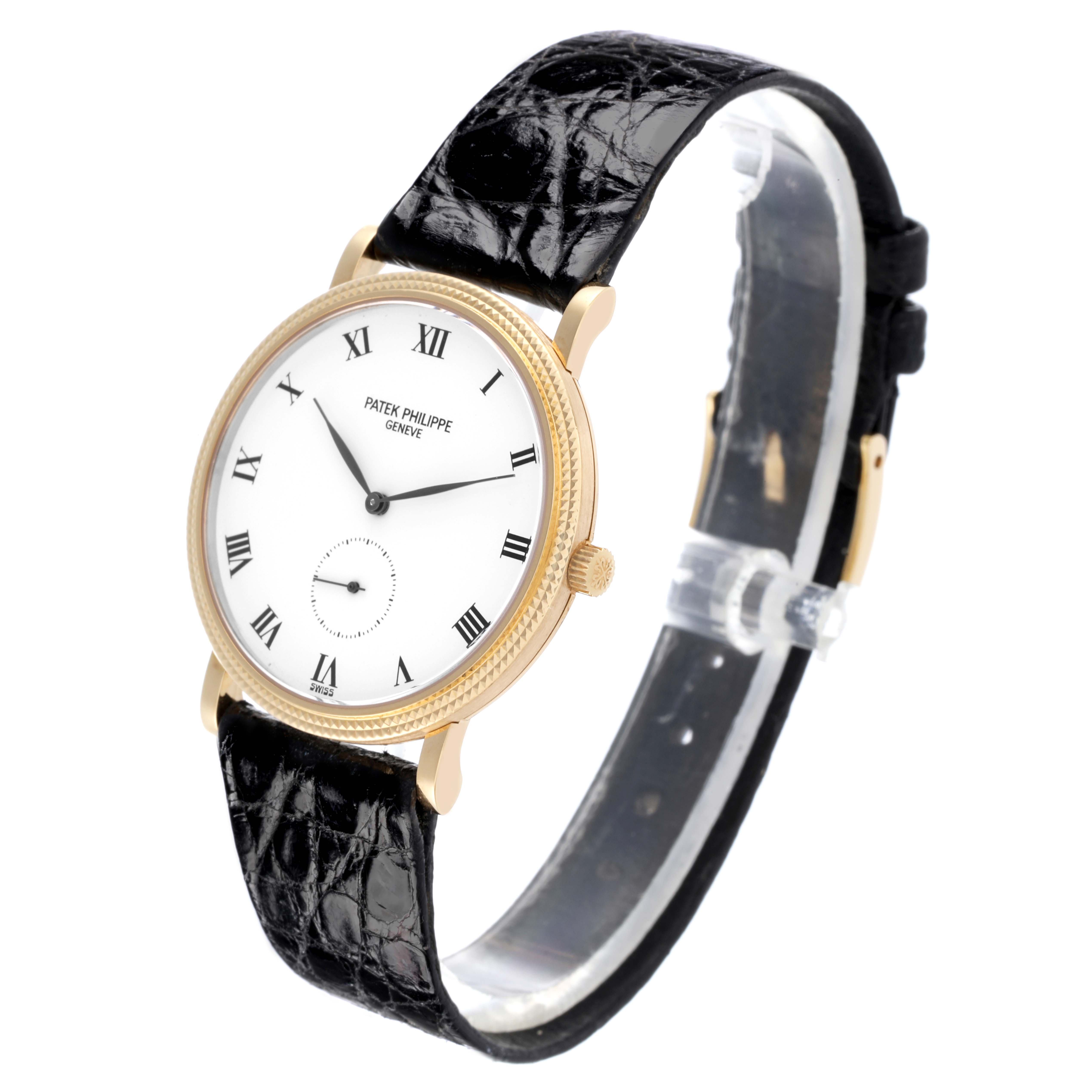 The Patek Philippe Calatrava 3919J Men's Yellow Gold White Dial 3919J Men's Yellow Gold White Dial watch is shown at a three-quarter angle, highlighting its dial, case, and leather strap.