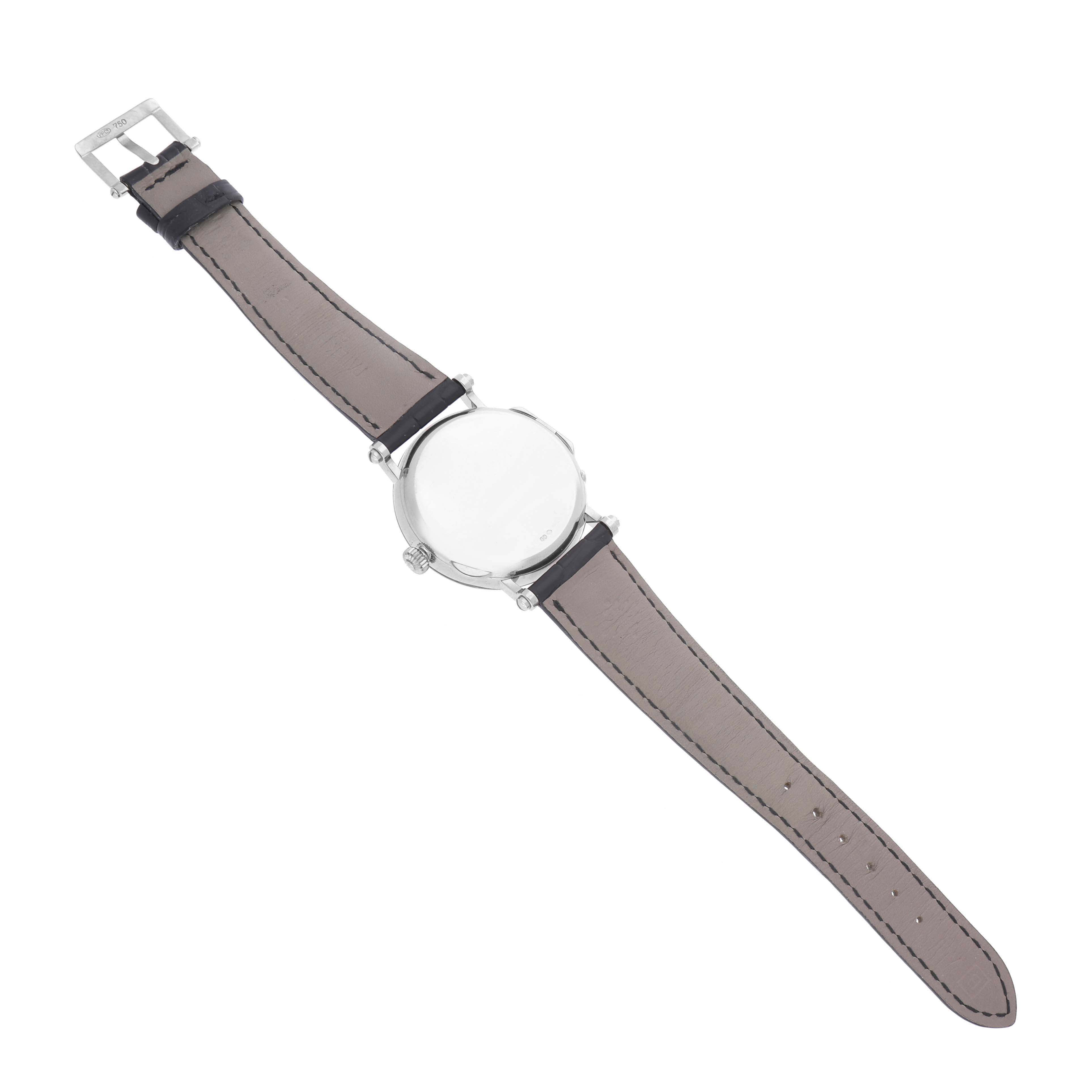 The Patek Philippe Complications 5015G Men's White Gold White Dial watch is shown from the back, displaying the leather strap and case back.