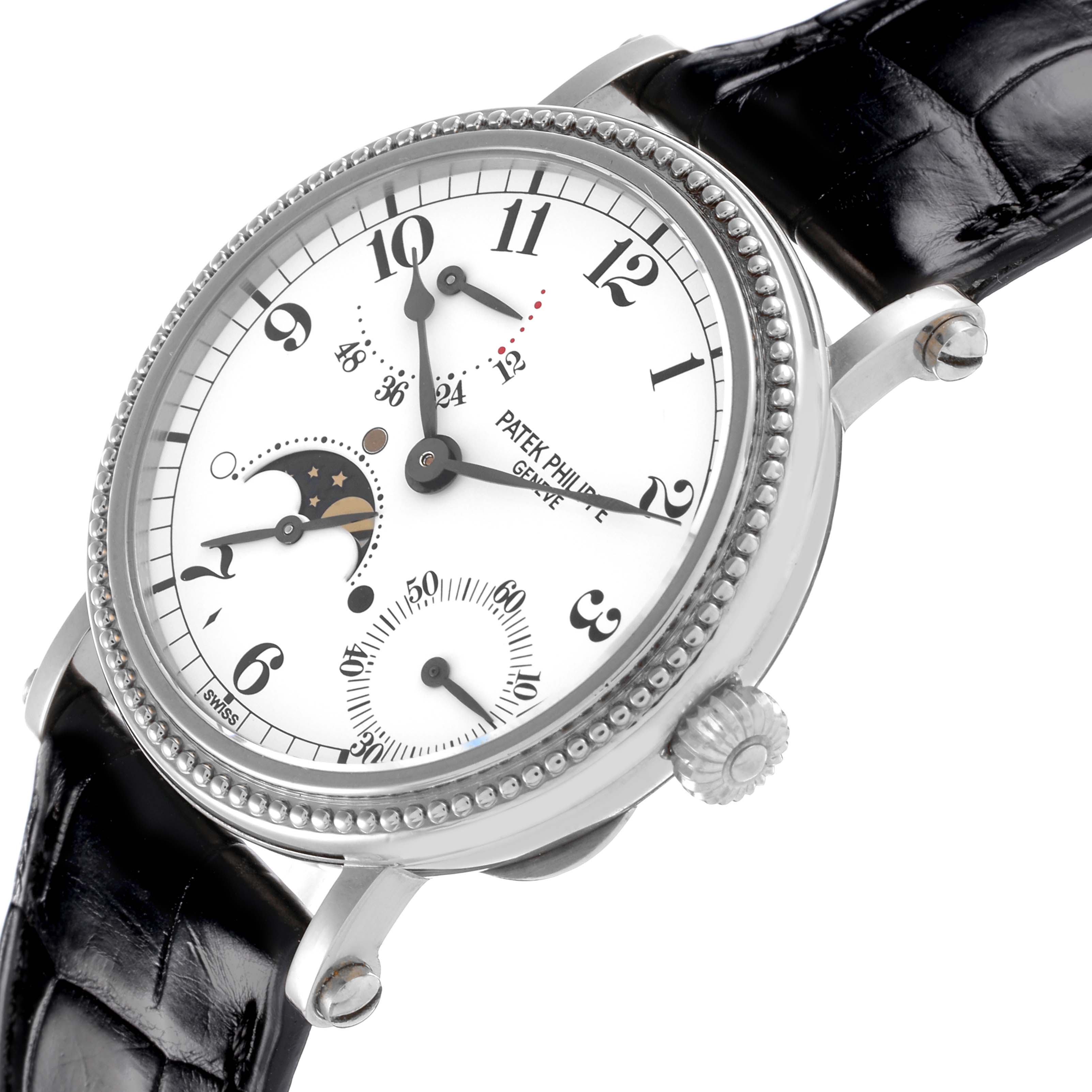 The Patek Philippe Complications 5015G Men's White Gold White Dial 5015G Men's White Gold White Dial watch is shown at an oblique angle, highlighting the dial, moon phase, and black leather strap.