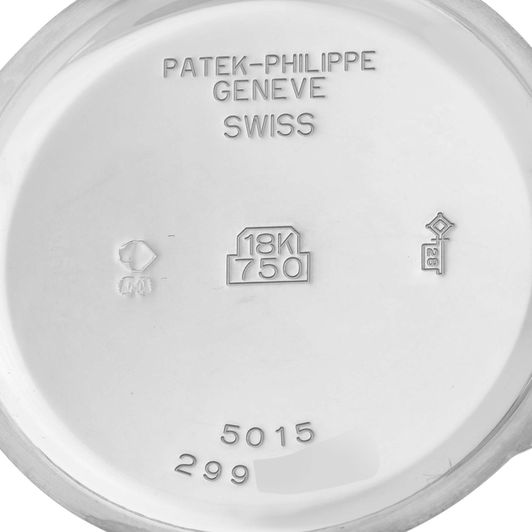 The image shows the inside case back of a Patek Philippe Complications 5015G Men's White Gold White Dial 5015G Men's White Gold White Dial watch, featuring inscriptions and hallmark stamps.