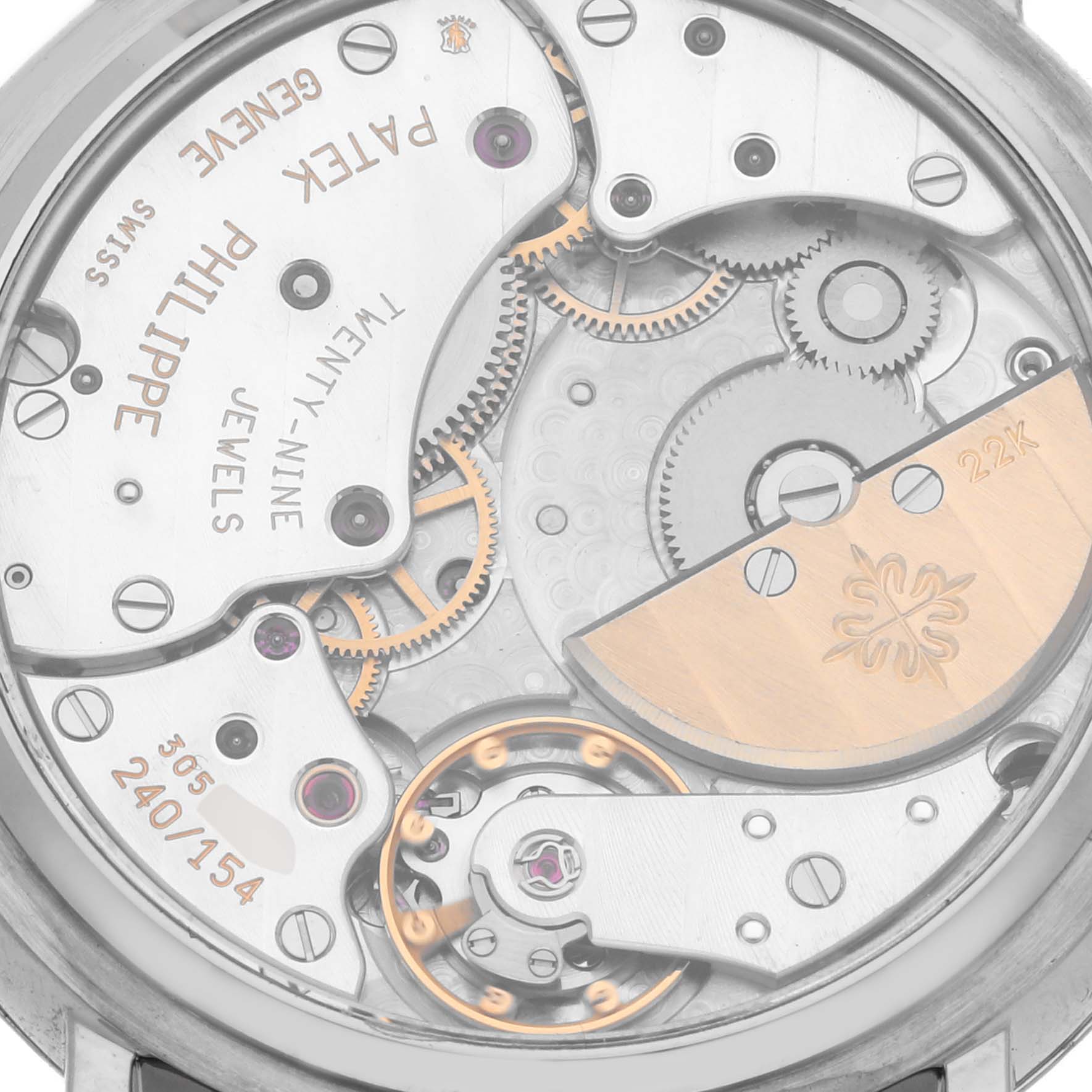 The image shows the intricate movement and gears of a Patek Philippe Complications 5015G Men's White Gold White Dial 5015G Men's White Gold White Dial model from a rear angle view.