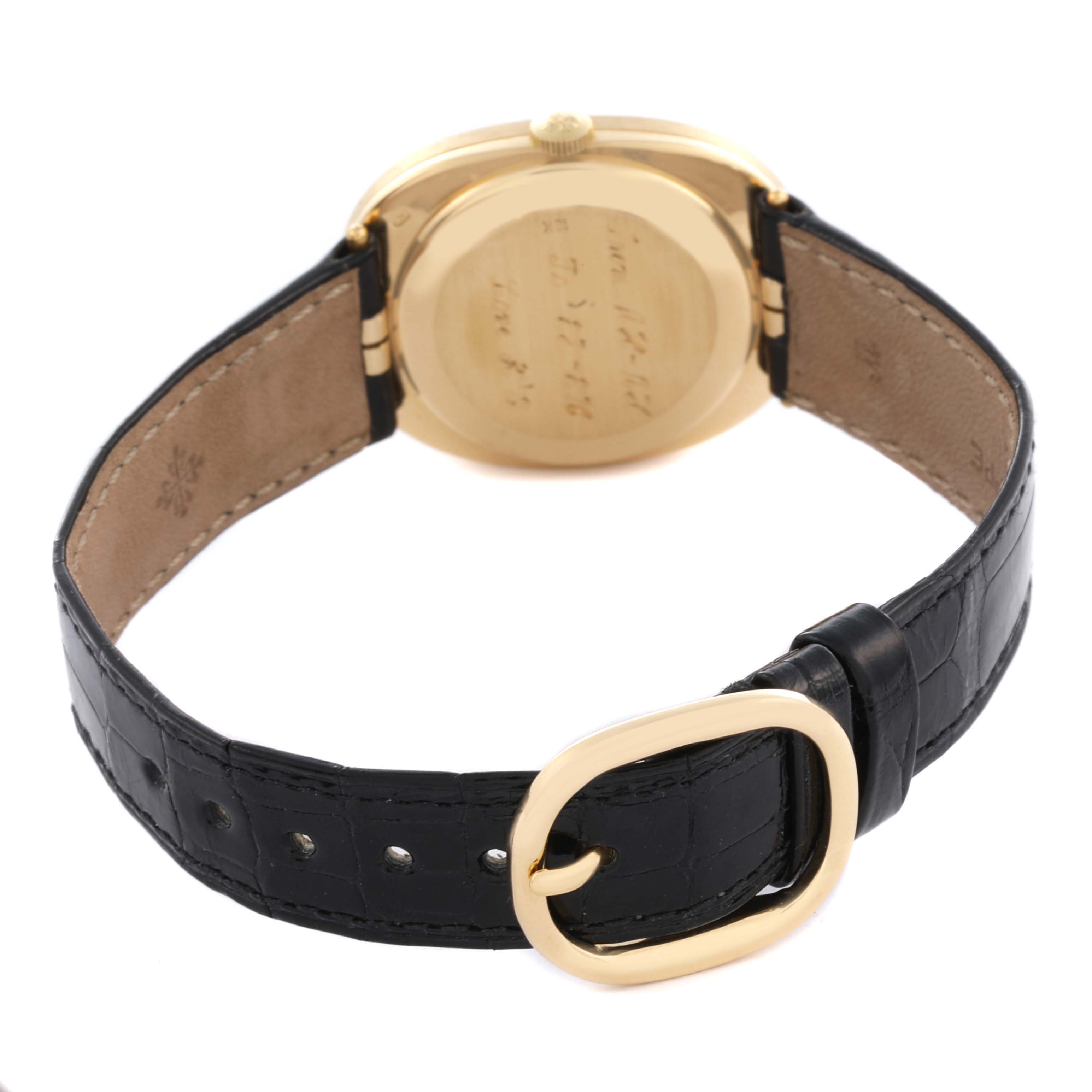 The Patek Philippe Golden Ellipse 3548 Men's Yellow Gold Blue Dial 3548 Men's Yellow Gold Blue Dial watch is shown from the back, highlighting the case back and black leather strap.