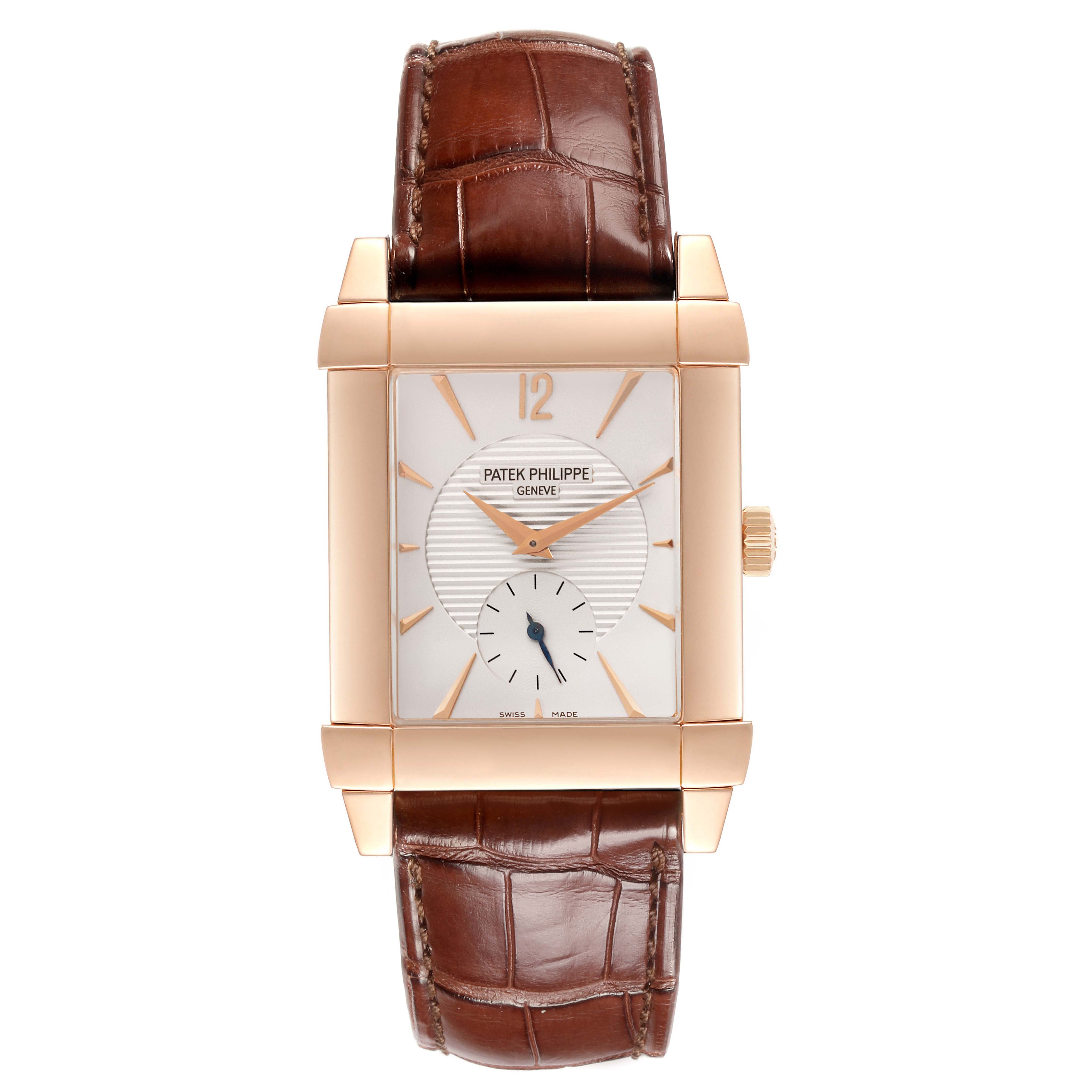 The Patek Philippe Gondolo 5111R-001 Men's Rose Gold Silver Dial 5111R-001 Men's Rose Gold Silver Dial watch is shown from a top-down angle, highlighting its rectangular face and brown leather strap.