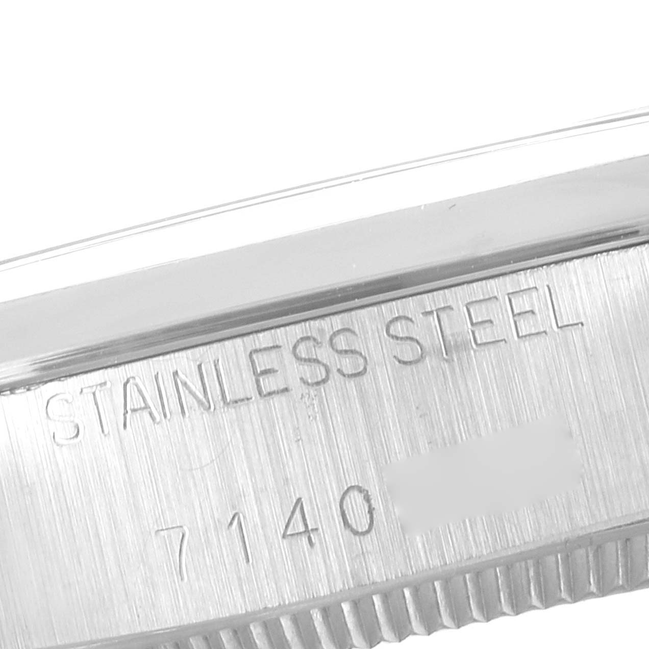 This image shows a close-up of the side engraving on a Rolex Air-King 5500 Men's Stainless Steel Silver Dial 5500 Men's Stainless Steel Silver Dial watch, displaying "STAINLESS STEEL" and the model number.