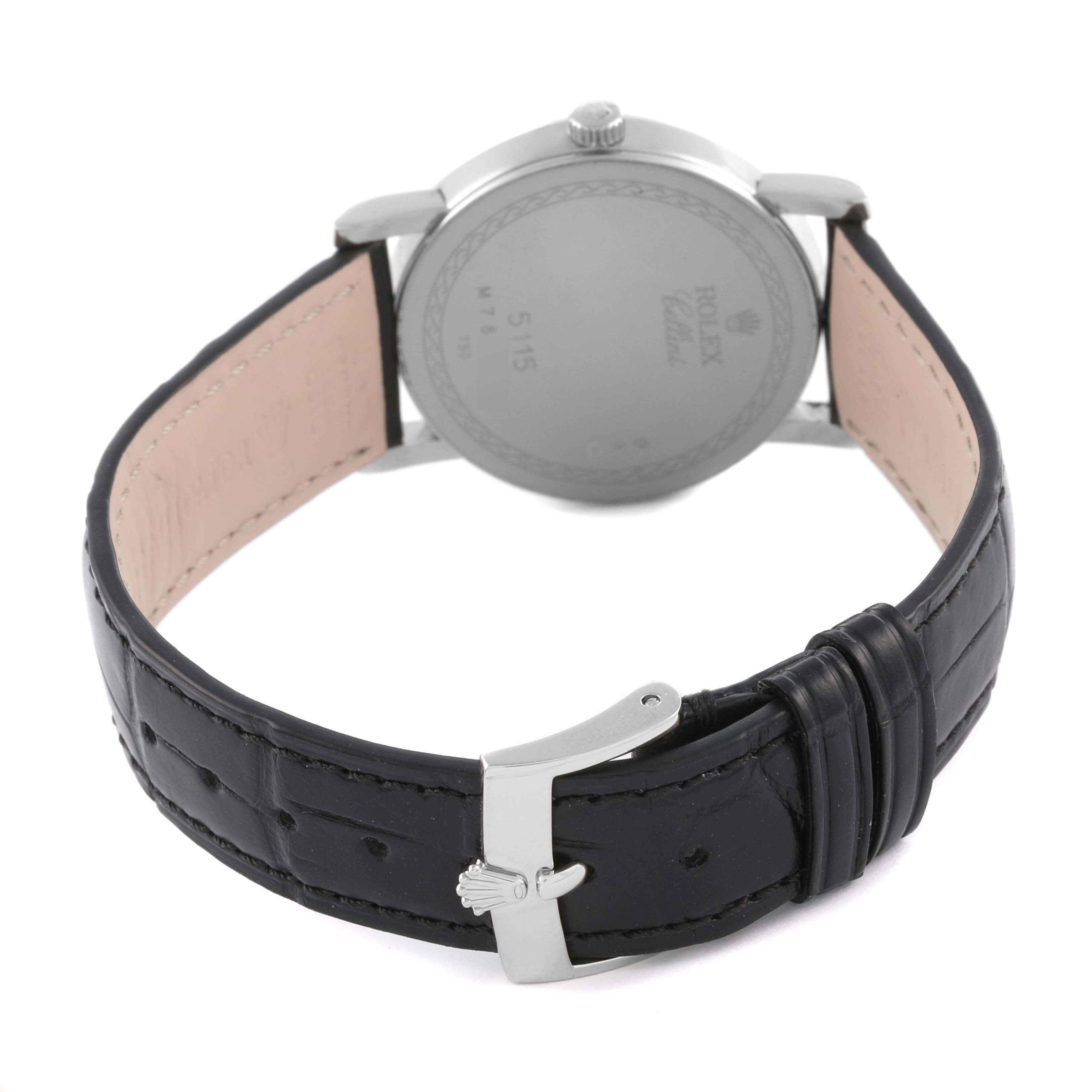 The Rolex Cellini 5115/9 Men's White Gold Silver Dial 5115/9 Men's White Gold Silver Dial watch is shown from the back, highlighting the case back and the black leather strap with a buckle.