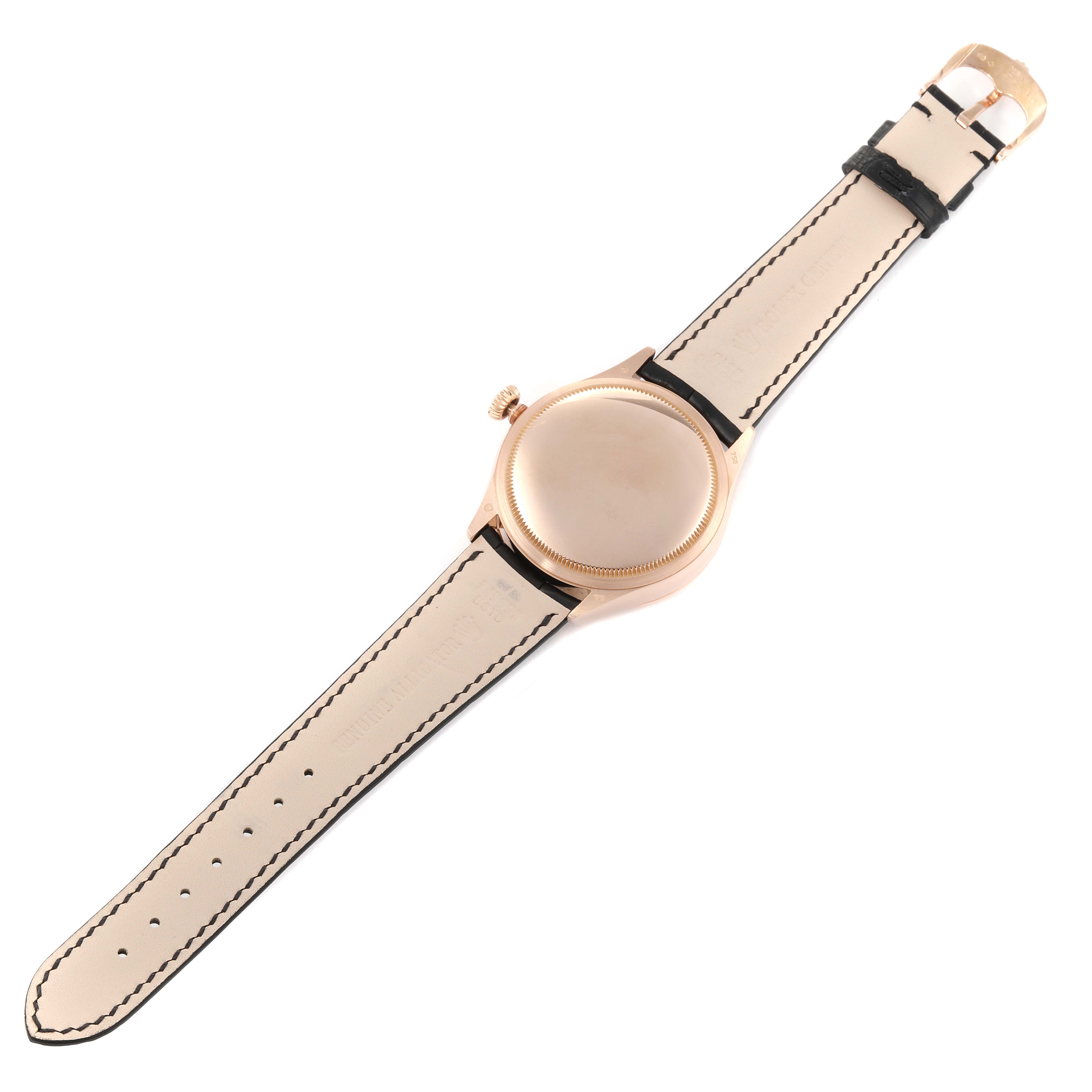 This image shows the back view of a Rolex Cellini 50515 Men
s Rose Gold Silver Dial 50515 Men
s Rose Gold Silver Dial watch laying flat, displaying its buckle, strap, case, and crown.