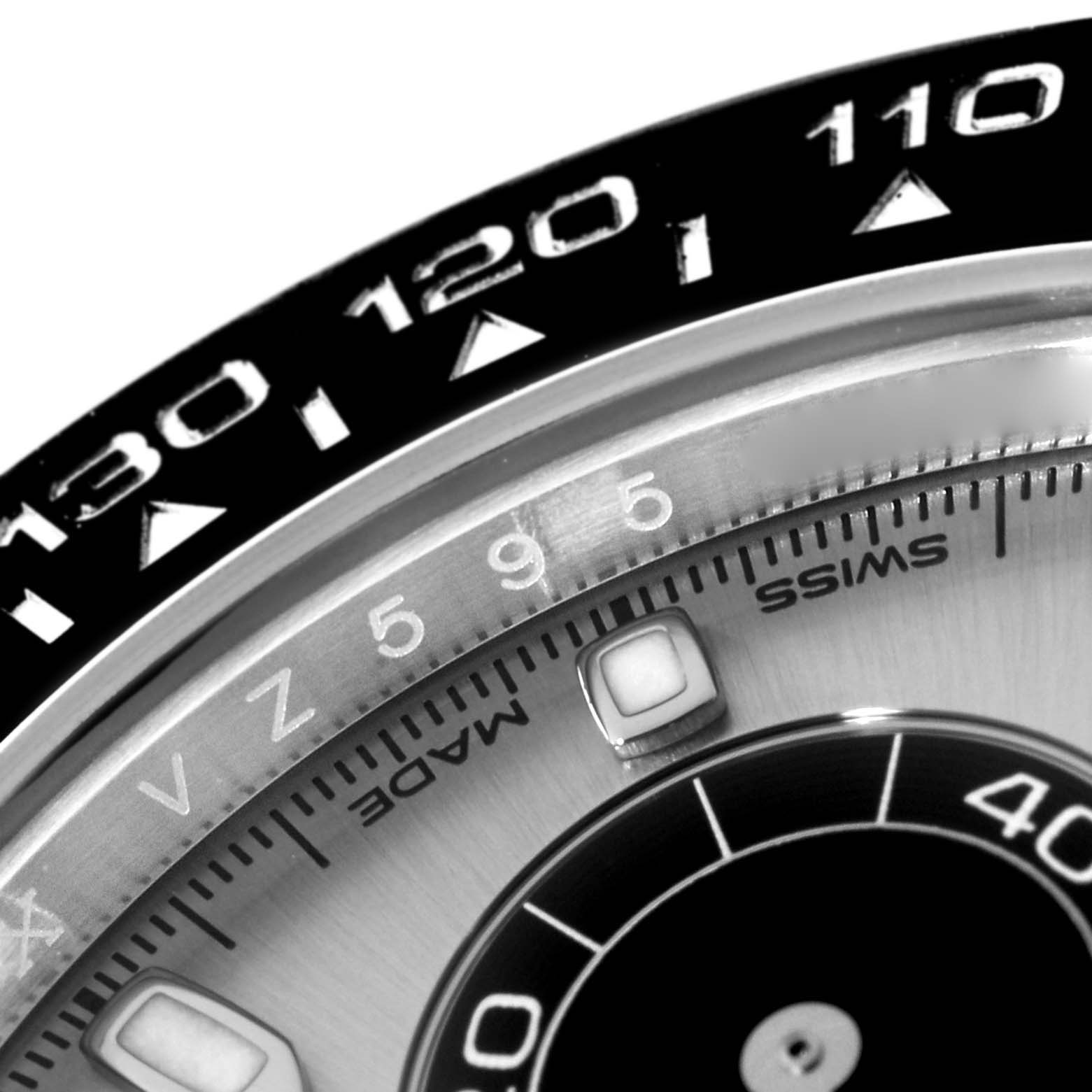 The image shows a close-up of the bezel and part of the dial of a Rolex Daytona 116519 Men's White Gold Grey Dial 116519 Men's White Gold Grey Dial watch, highlighting the tachymeter scale and part of the minute markers.