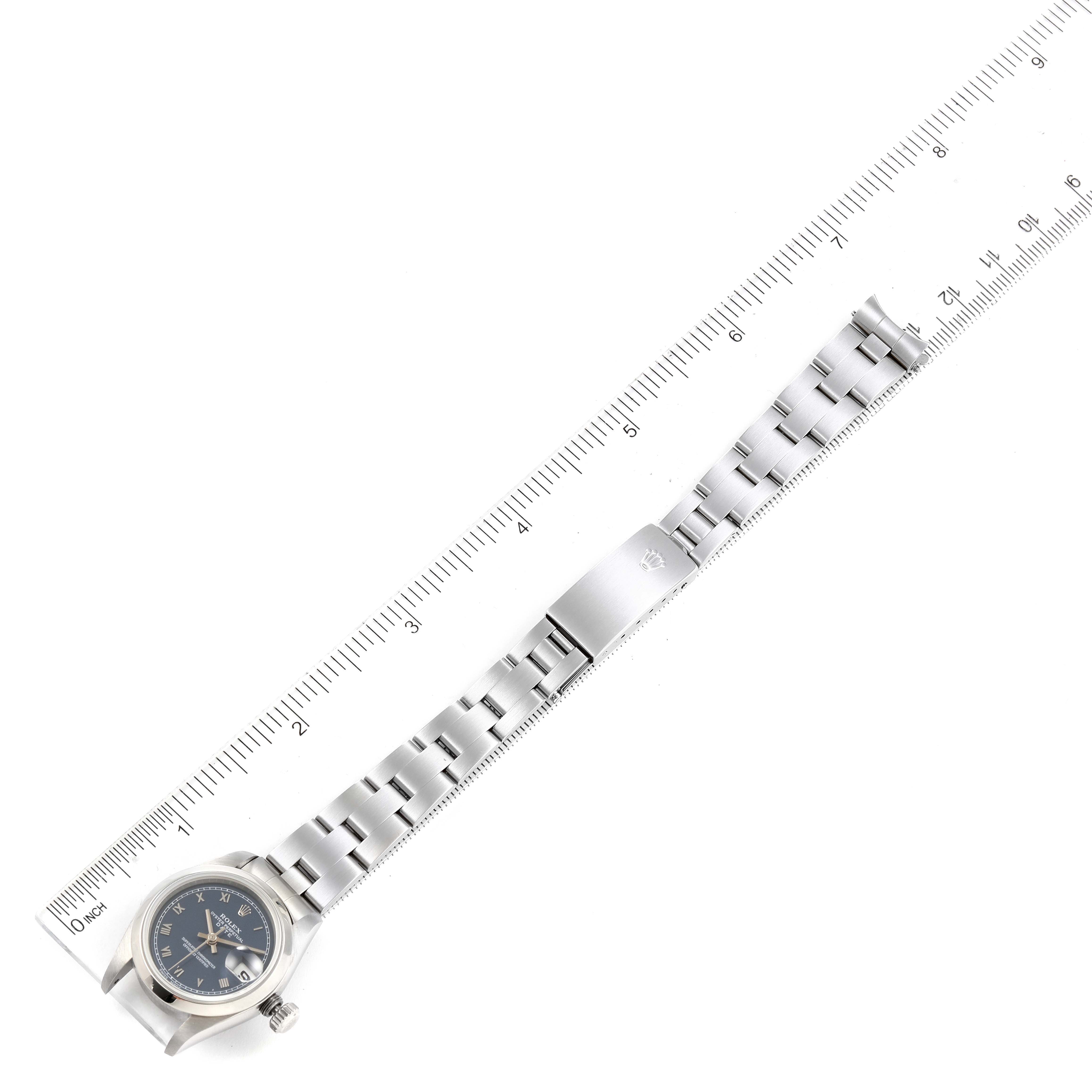 The image shows the front view of a Rolex Date 69160 Women's Stainless Steel Blue Dial 69160 Women's Stainless Steel Blue Dial model watch and its full metal bracelet against a ruler for scale.