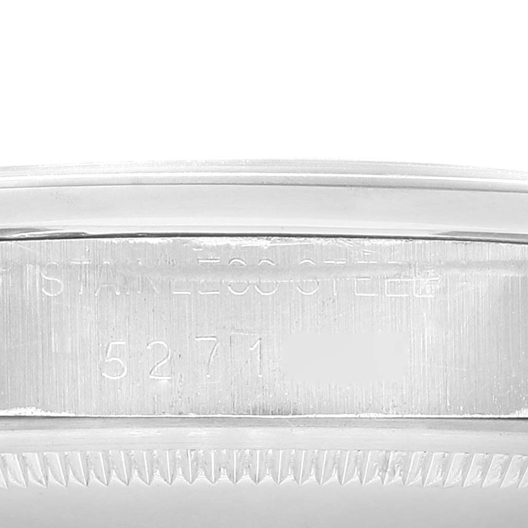 This image shows a close-up of the Rolex Date 1500 Men
s Stainless Steel Black Dial 1500 Men
s Stainless Steel Black Dial model, focusing on the engraved case
s serial numbers and part details.