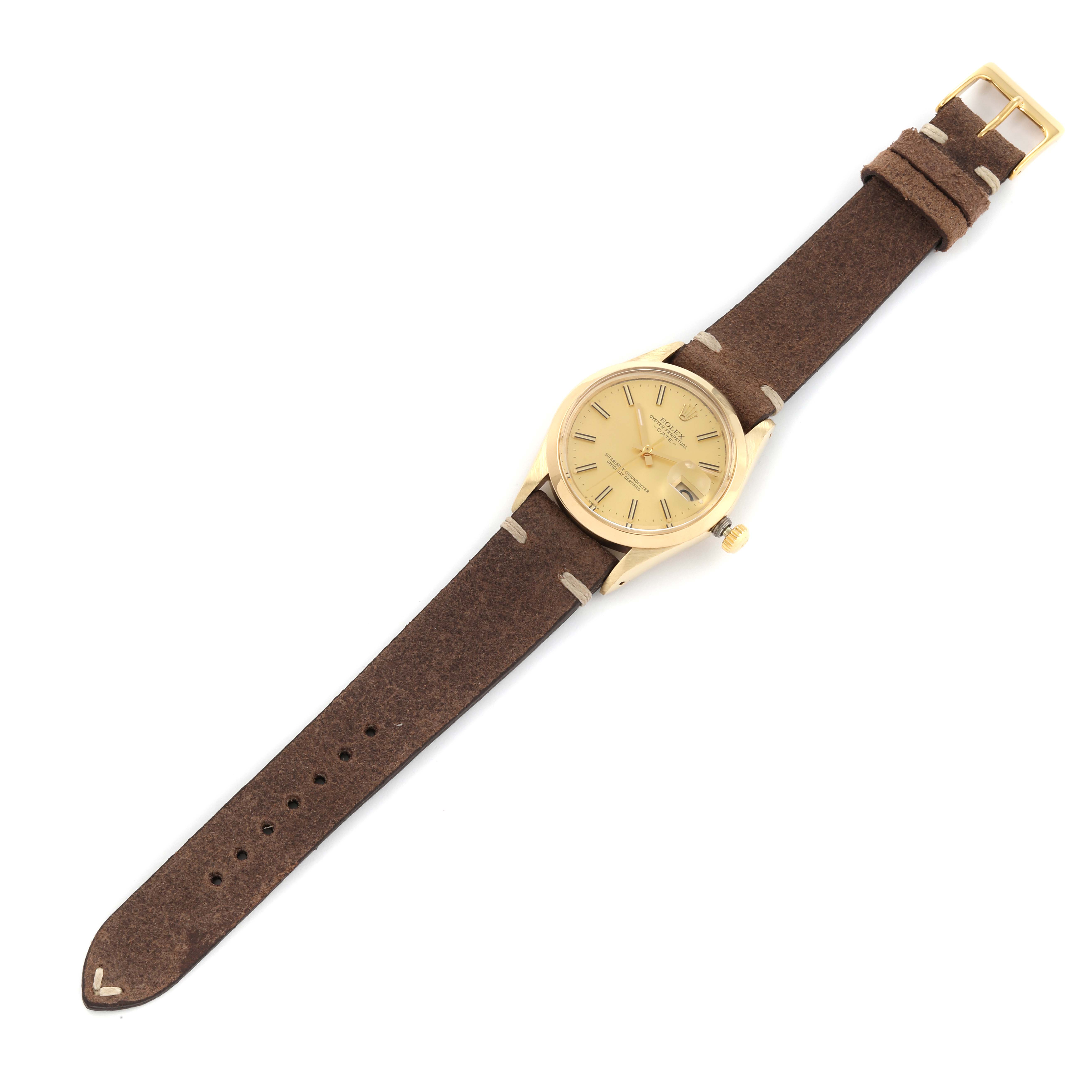 The image shows a Rolex Vintage Collection 15007 Men's Yellow Gold Champagne Dial 15007 Men's Yellow Gold Champagne Dial watch from a top-down angle, featuring a brown leather strap and a gold dial.