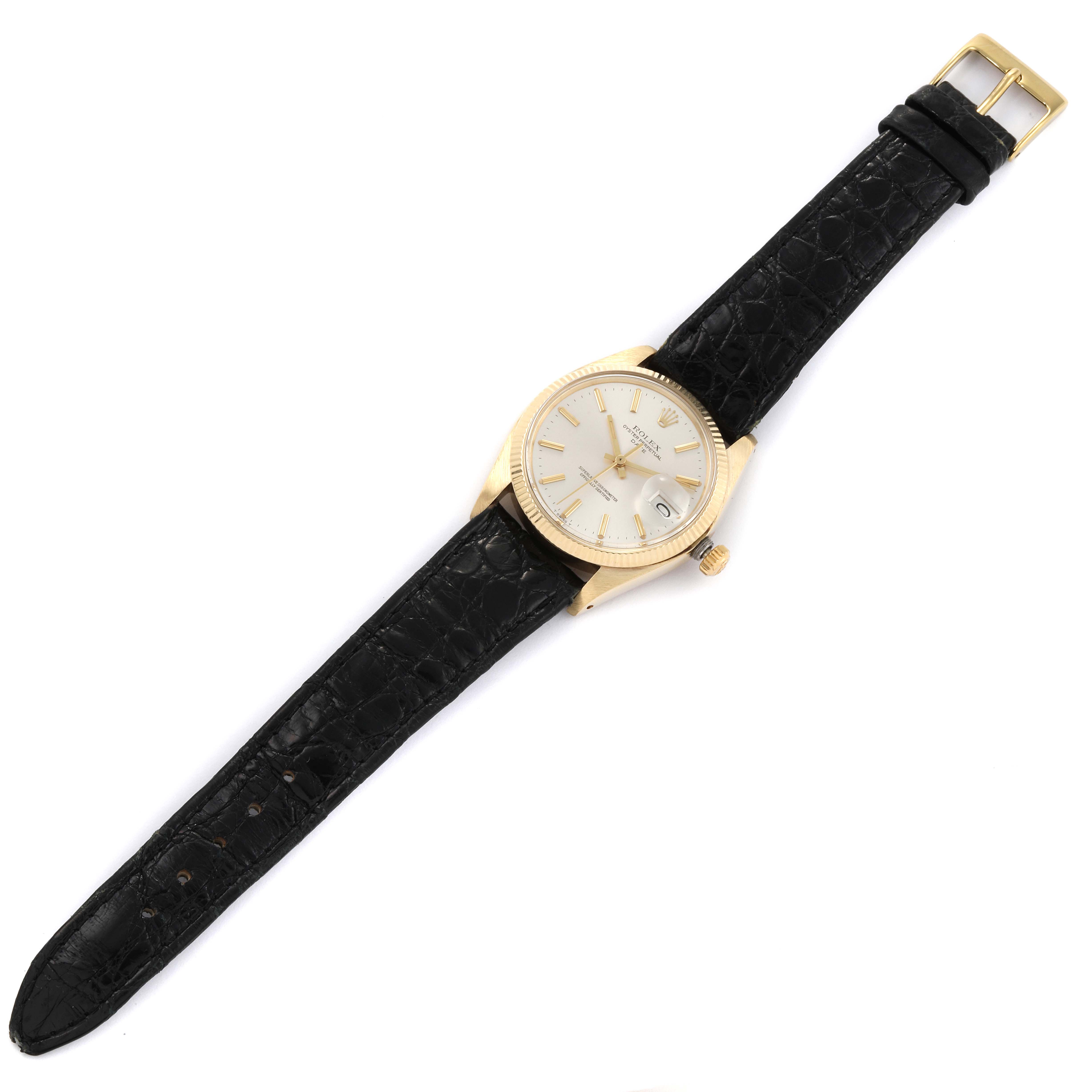 The Rolex Vintage Collection 1503 Men's Yellow Gold Champagne Dial 1503 Men's Yellow Gold Champagne Dial watch is shown from a top-down angle, displaying its black leather strap, gold casing, and dial.