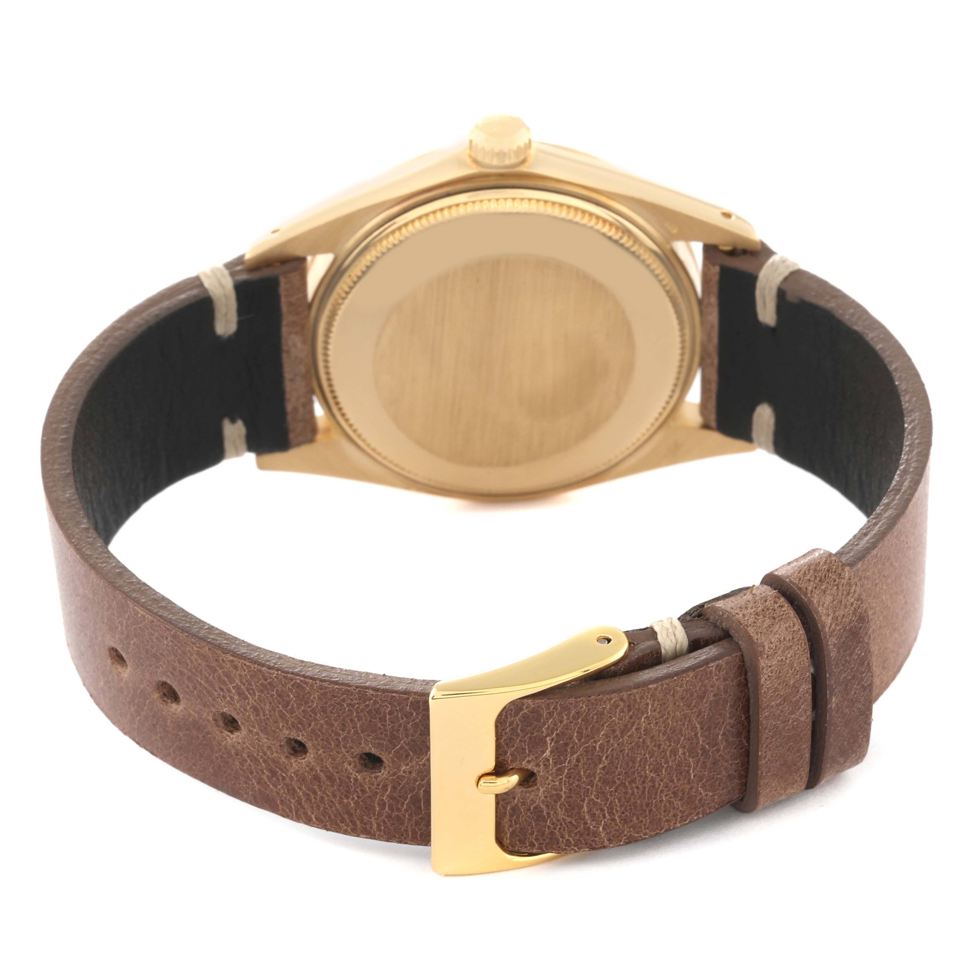 The image shows the back and side of a Vintage Collection Rolex watch with a brown leather strap and gold-tone casing.