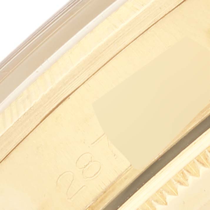 The image shows a close-up of the marked gold bezel and case of the Rolex Vintage Collection 1511 Men's Yellow Gold Champagne Dial 1511 Men's Yellow Gold Champagne Dial watch.