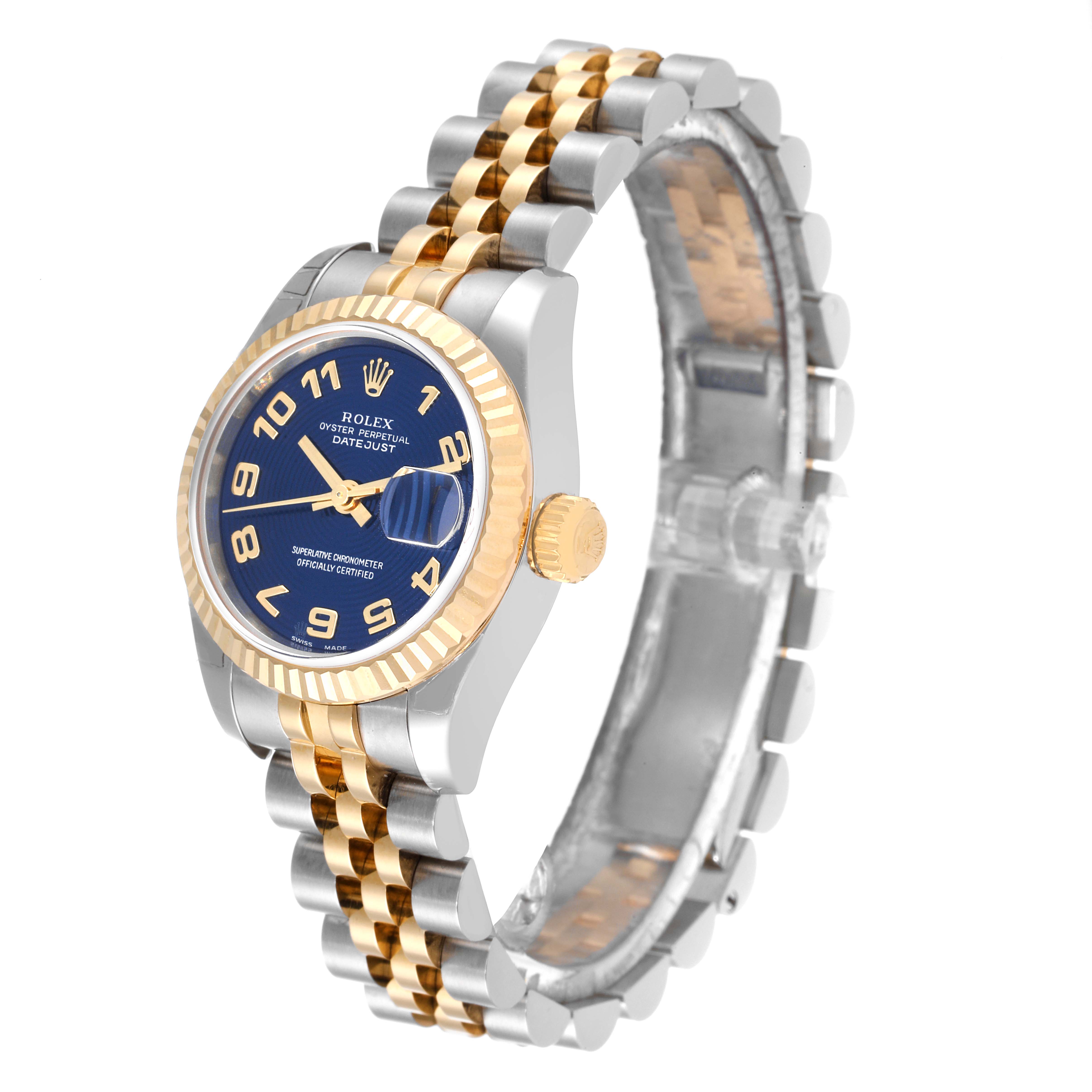 The image shows a Rolex Datejust 179173 Women's Steel and Gold (two tone) Blue Dial 179173 Women's Steel and Gold (two tone) Blue Dial watch with a blue dial, gold fluted bezel, and two-tone bracelet from a side angle.