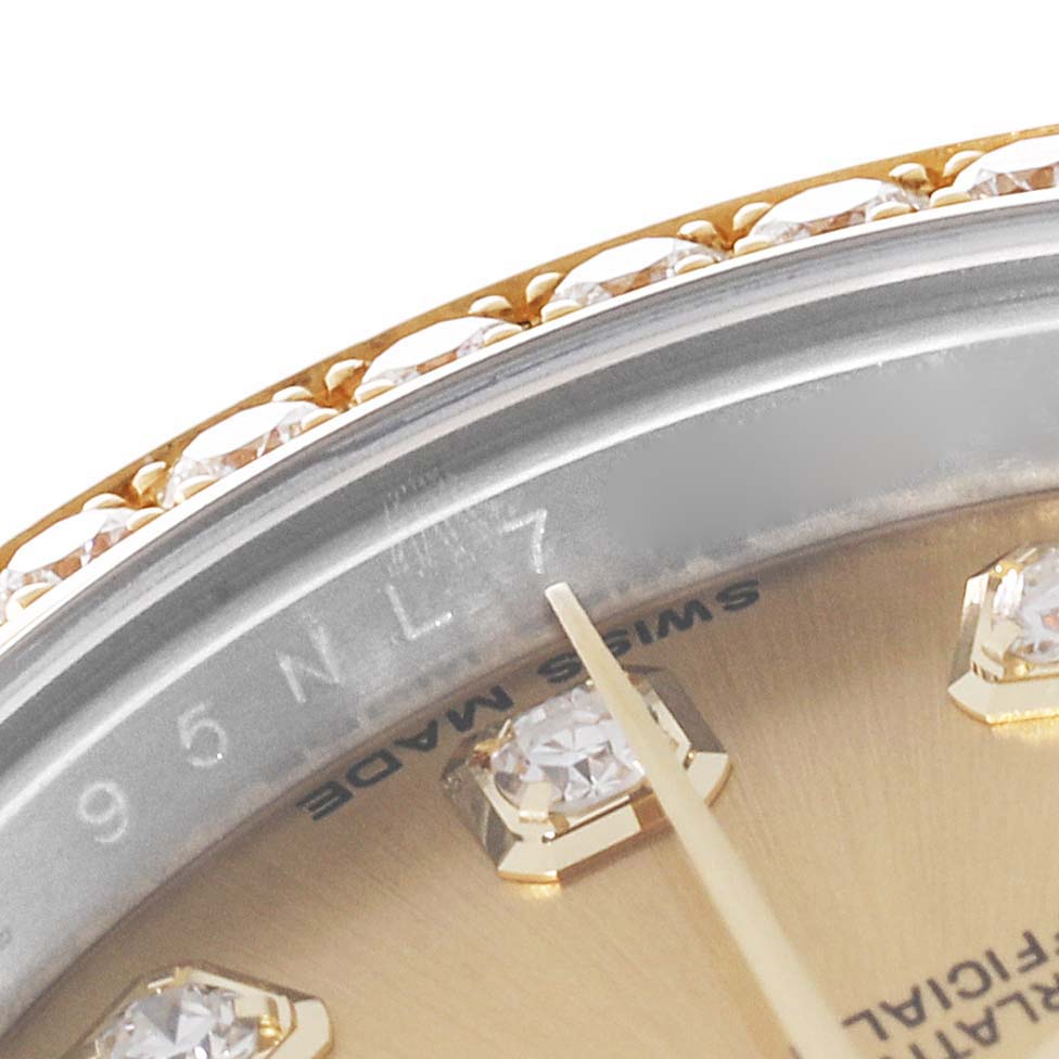 This image shows a close-up of the bezel and part of the dial of a Rolex Datejust 179383 Women's Steel and Gold (two tone) Champagne Dial 179383 Women's Steel and Gold (two tone) Champagne Dial, featuring diamond decorations.
