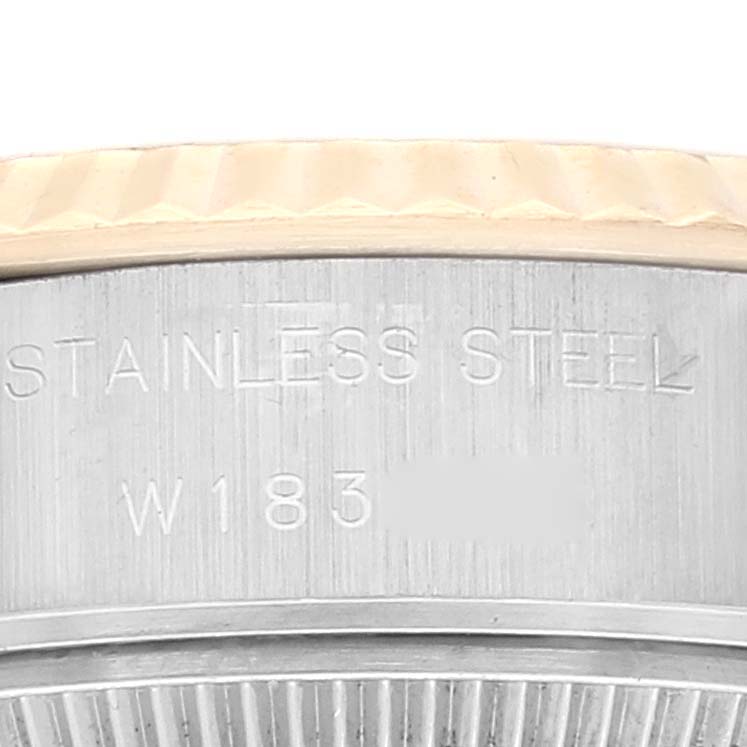 This image shows a close-up view of the case back and bezel edge of a Rolex Datejust 69173 Women's Steel and Gold (two tone) Champagne Dial 69173 Women's Steel and Gold (two tone) Champagne Dial watch, highlighting the stainless steel inscription.