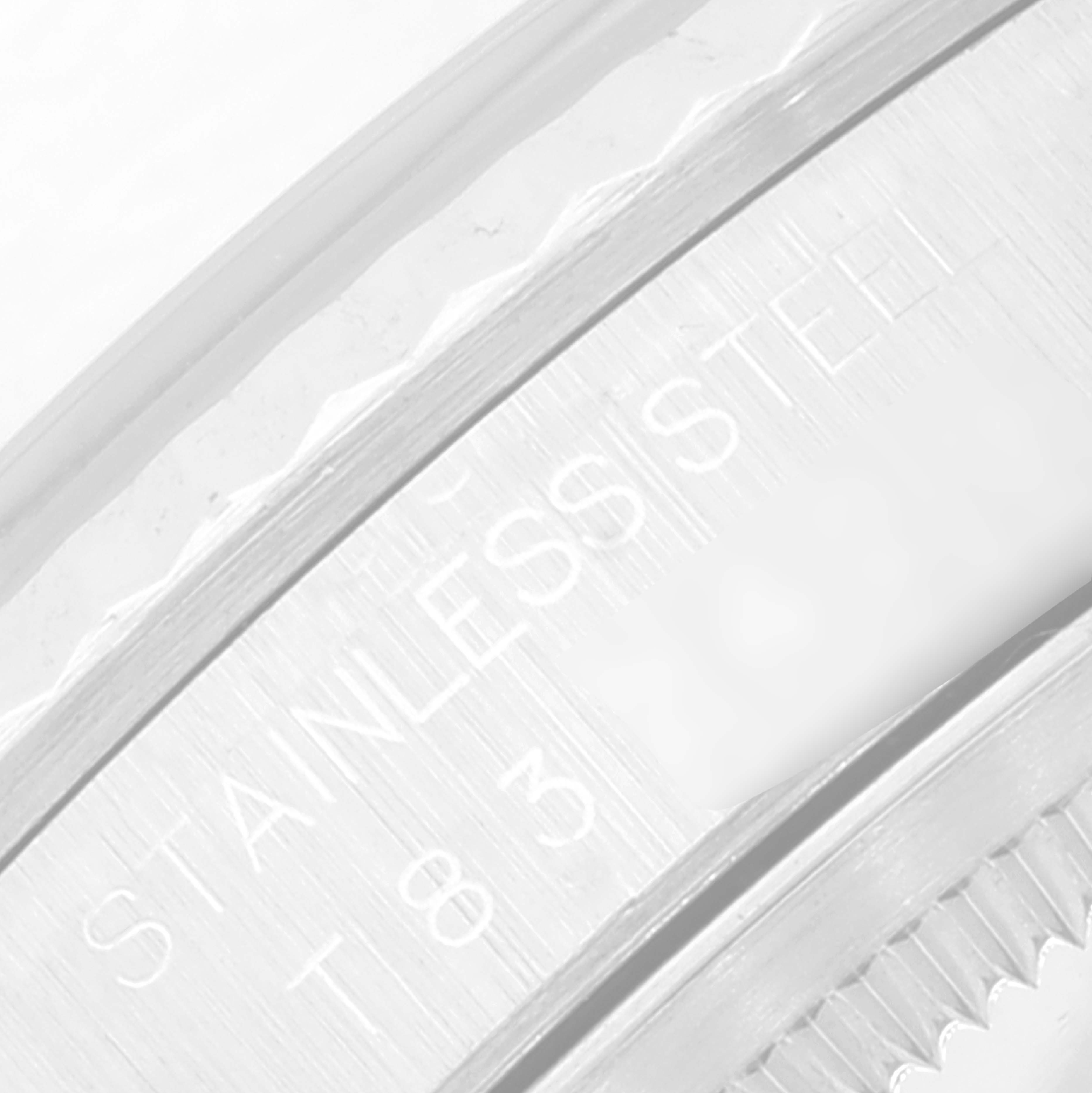 This image shows a close-up of the stainless steel bezel and engravings on a Rolex Datejust 16234 Men's Stainless Steel Blue Dial 16234 Men's Stainless Steel Blue Dial watch.