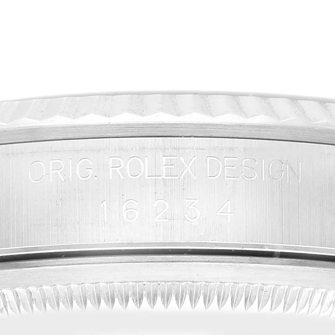 This image shows a close-up of the side and part of the fluted bezel of a Rolex Datejust 16234 Men's Stainless Steel Silver Dial 16234 Men's Stainless Steel Silver Dial watch, displaying its engraved model number.