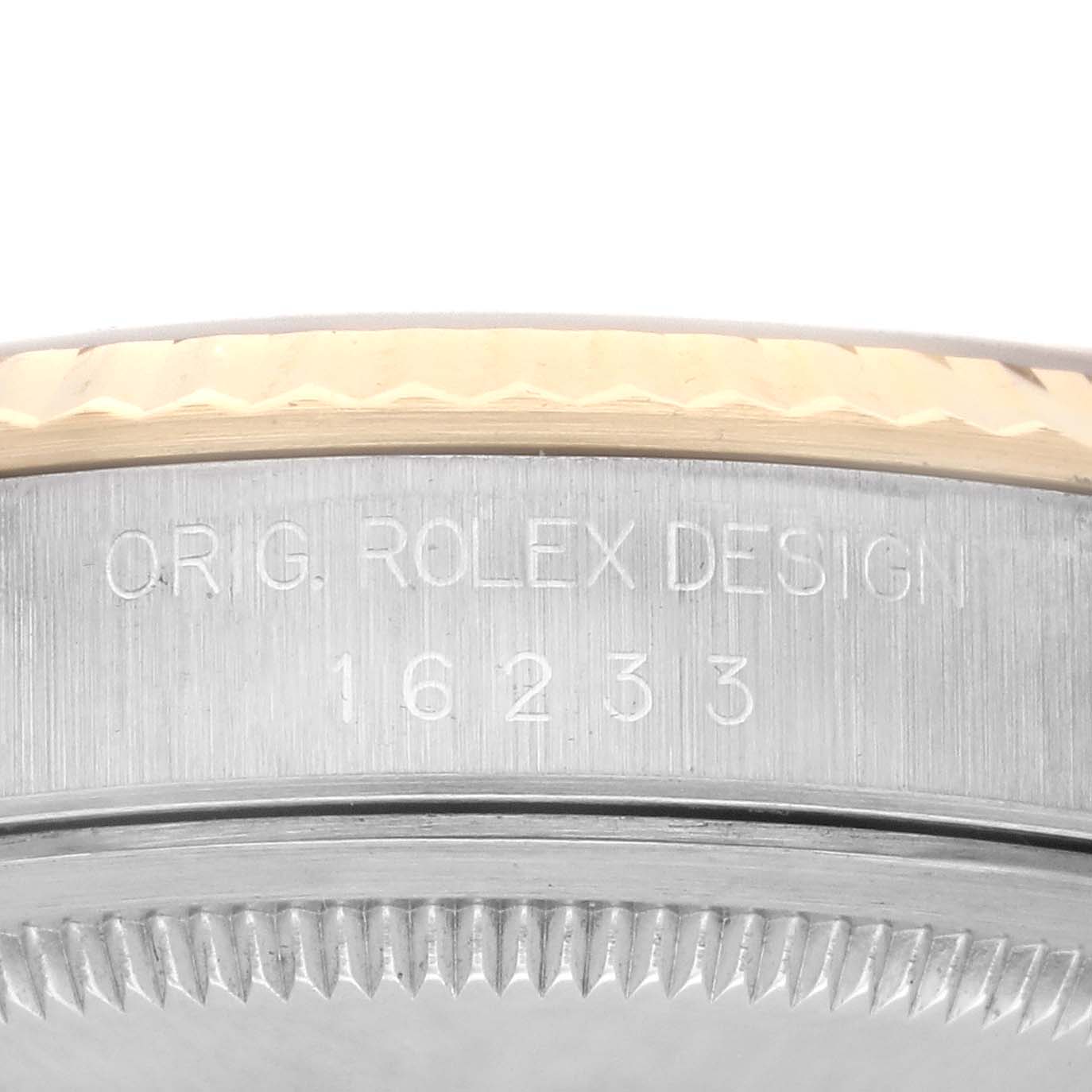 The image shows a close-up angle of the Rolex Datejust 16233 Men's Steel and Gold (two tone) Champagne Dial 16233 Men's Steel and Gold (two tone) Champagne Dial model's side, highlighting the bezel and case with design engraving.