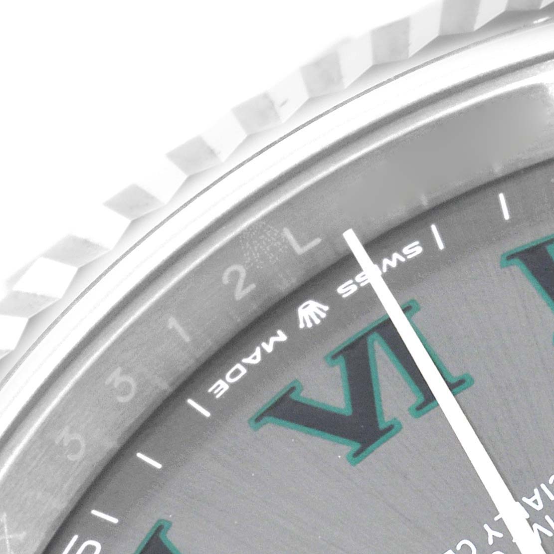 This close-up image of a Rolex Datejust 41 126334 Men
s Stainless Steel Grey Dial 126334 Men
s Stainless Steel Grey Dial model shows a partial view of the fluted bezel and dial with the "SWISS MADE" label.
