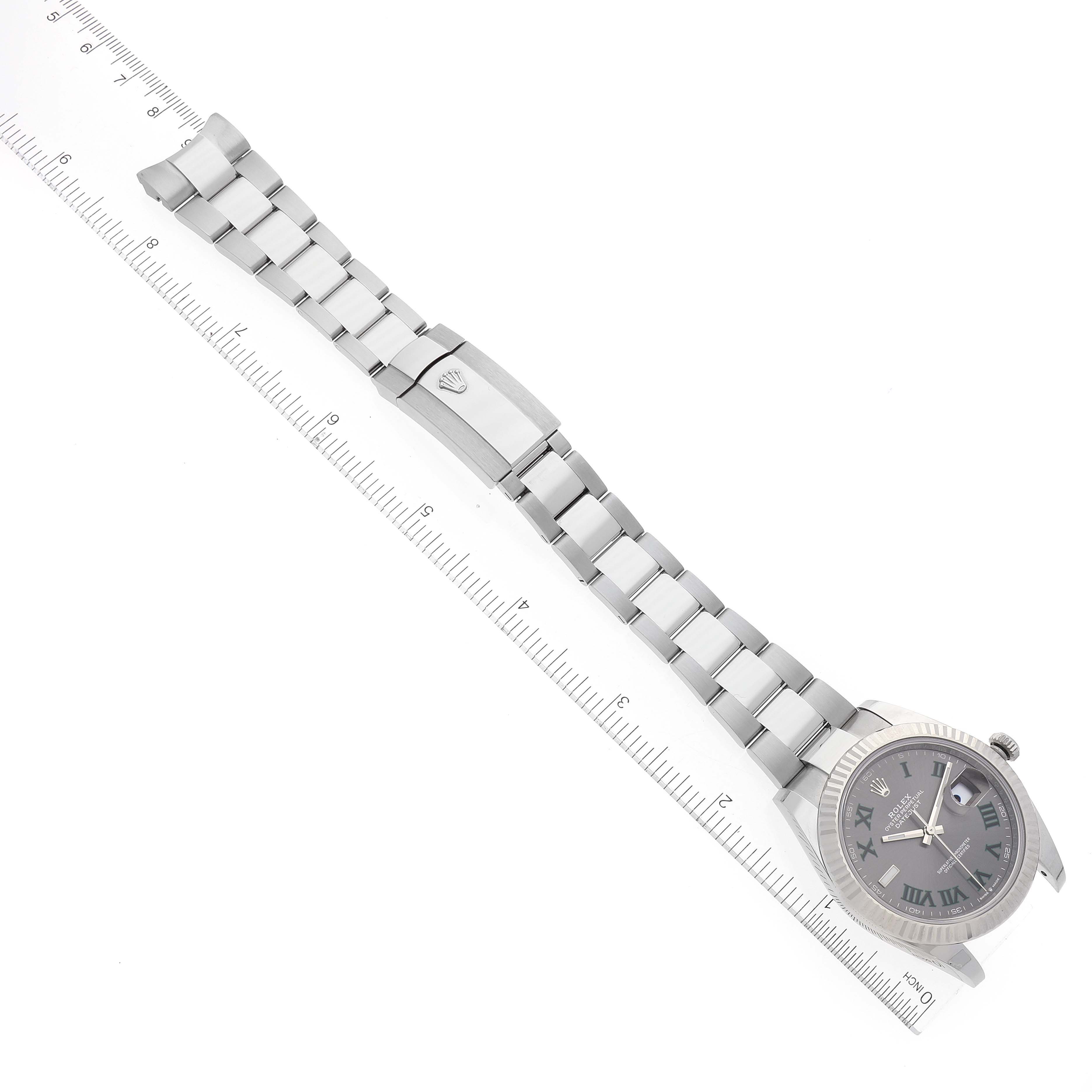 This image shows a Rolex Datejust 41 126334 Men
s Stainless Steel Grey Dial 126334 Men
s Stainless Steel Grey Dial watch laid flat with a ruler for scale, featuring the face, bracelet, and clasp.