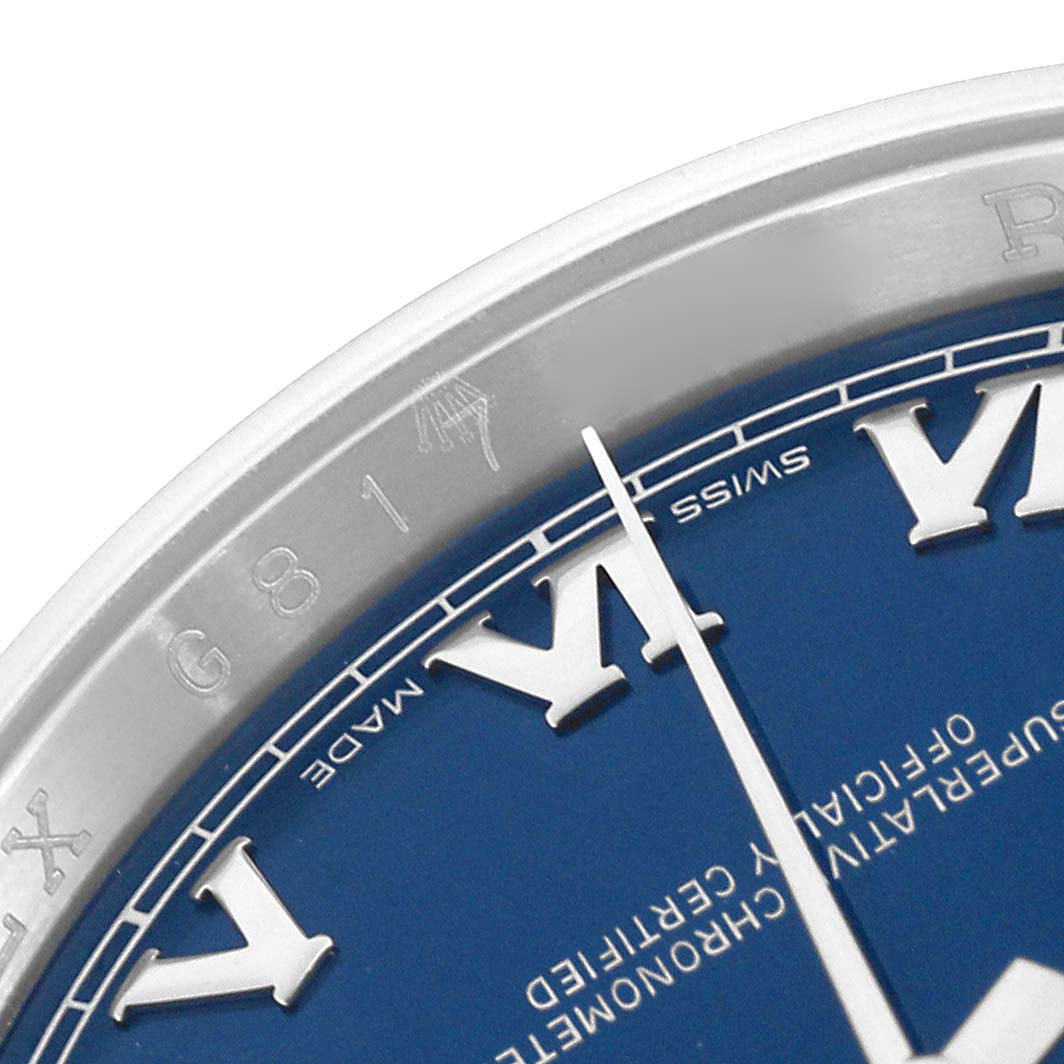 This image shows a close-up of the dial and bezel of a Rolex Datejust 116200 Men
s Stainless Steel Blue Dial 116200 Men
s Stainless Steel Blue Dial, focusing on Roman numerals and markings.