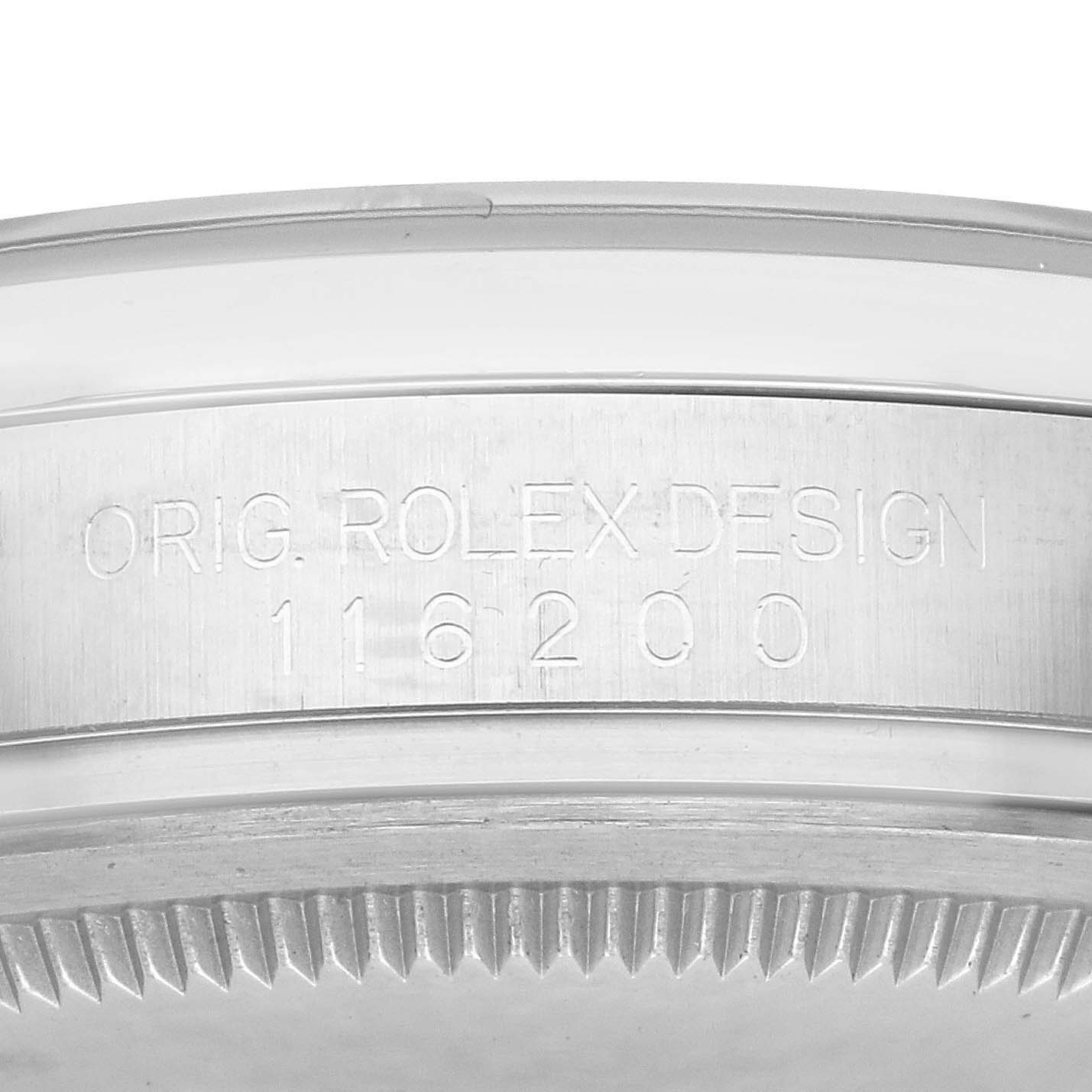 The image shows the side of the Rolex Datejust 116200 Men
s Stainless Steel Blue Dial 116200 Men
s Stainless Steel Blue Dial case, featuring the model number and engraving.