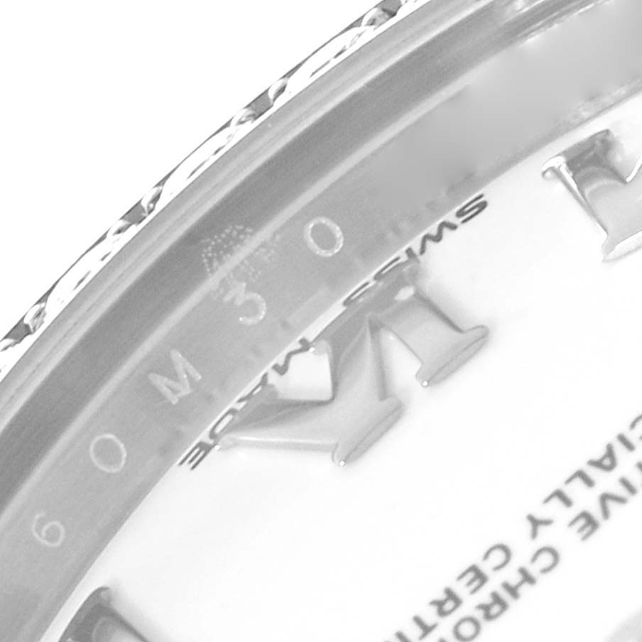 The image shows a close-up angle of the dial and bezel of a Rolex Mid-Size 178384 Women
s Stainless Steel White Dial 178384 Women
s Stainless Steel White Dial model watch, with partial view of the text and hour markers.