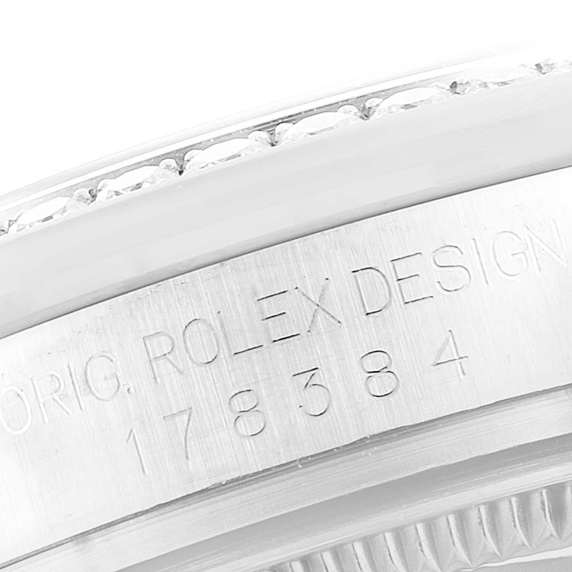 This image shows a close-up of the side of a Mid-Size Rolex watch with the model number engraved.
