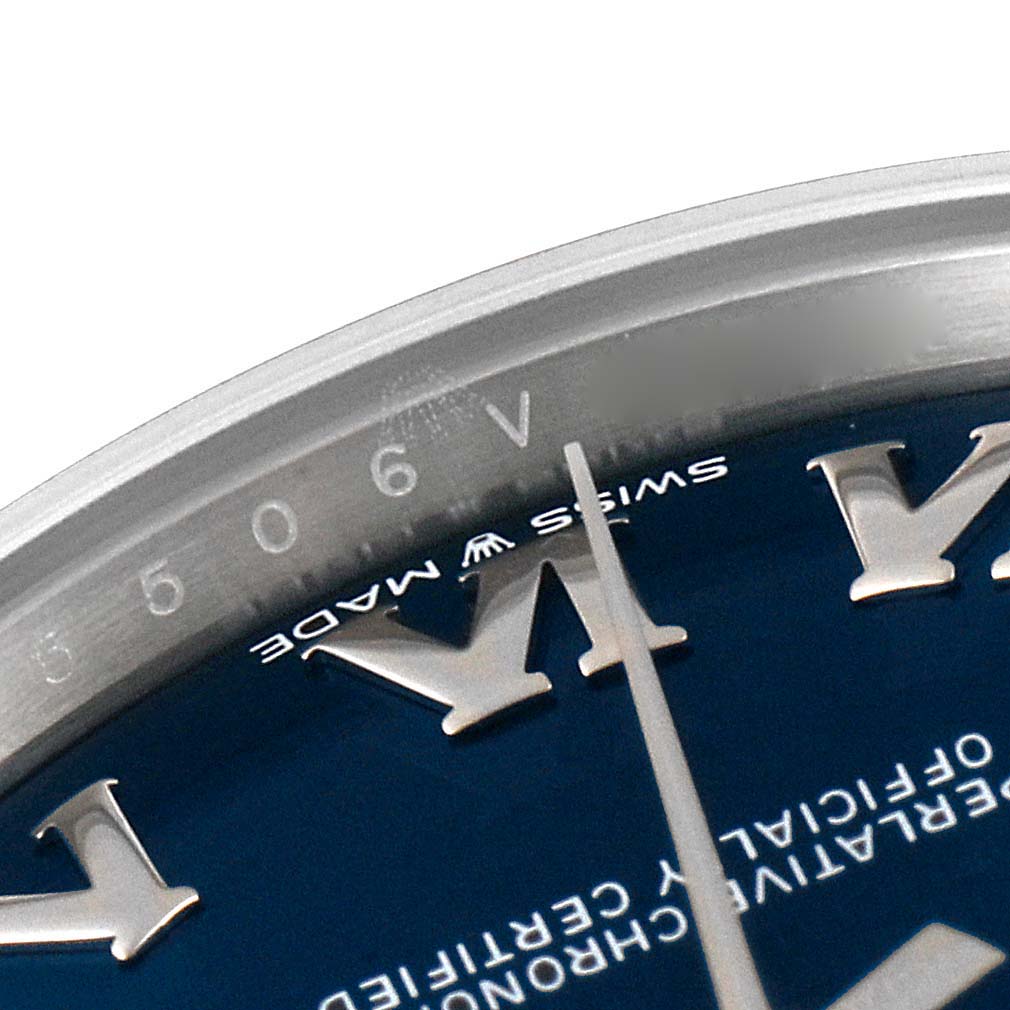 The image shows a close-up of the dial and bezel of a mid-size Rolex watch, highlighting the "Swiss Made" label and minute markers.