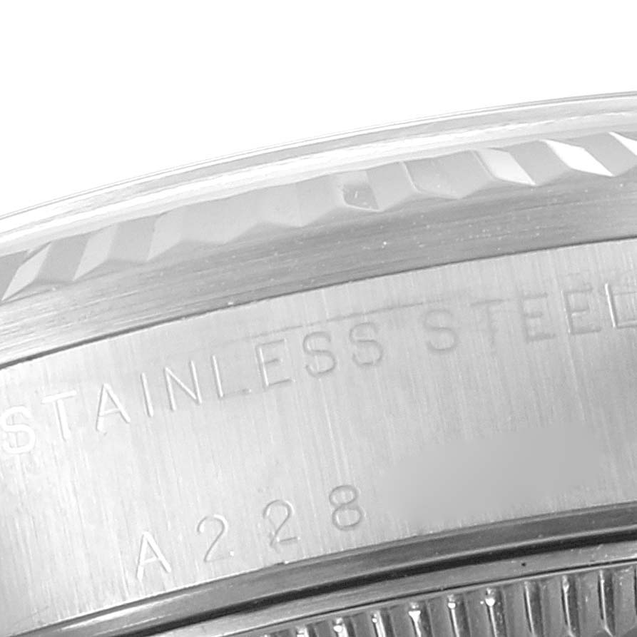 This close-up image shows the rim and part of the casing with stainless steel markings on a Rolex Mid-Size 78274 Women's Stainless Steel Silver Dial 78274 Women's Stainless Steel Silver Dial watch.