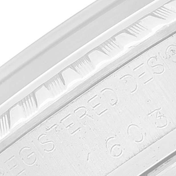 The image shows a close-up view of the bezel and part of the engraved text on a Rolex Vintage Collection 1603 Men
s Stainless Steel Silver Dial 1603 Men
s Stainless Steel Silver Dial watch.