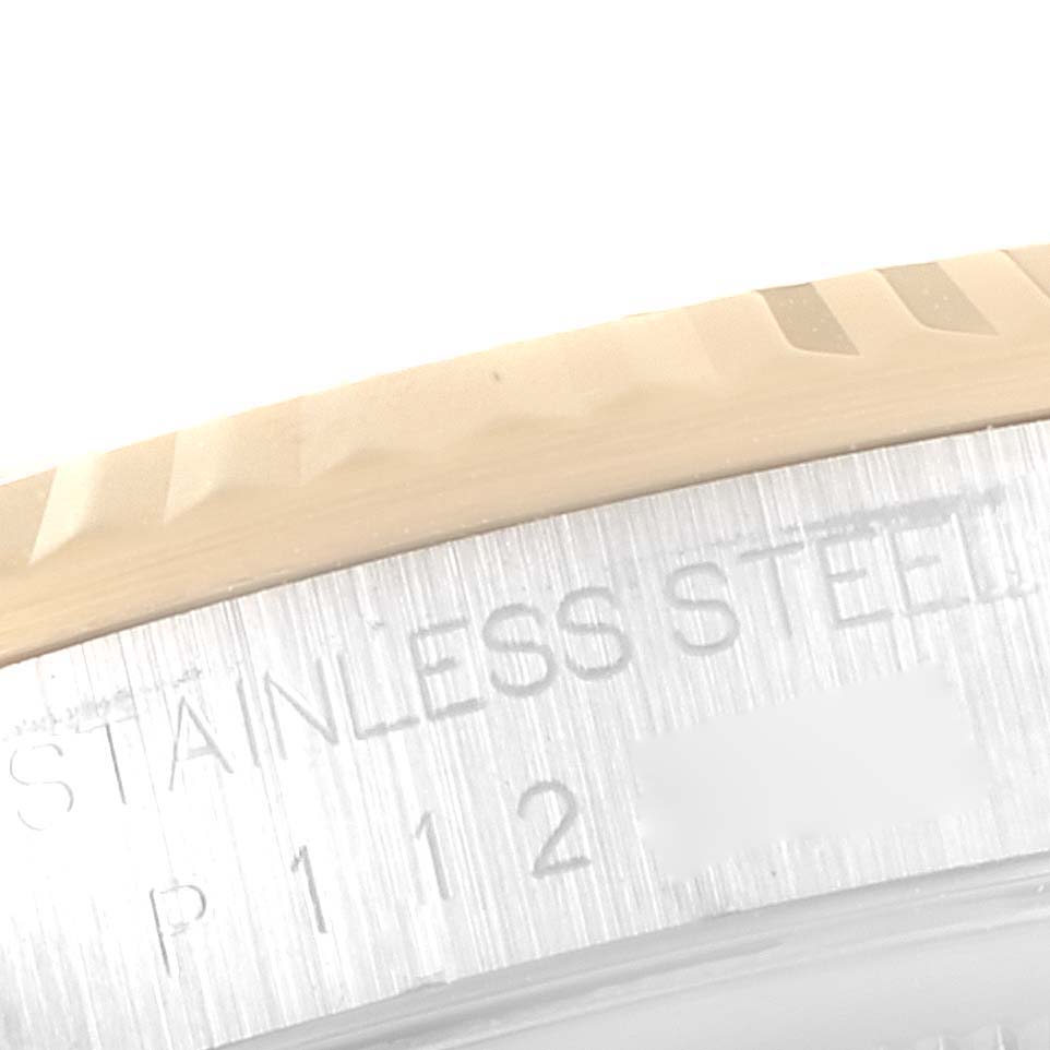 This close-up image shows the bezel and part of the case-back engraving of a Rolex Datejust 16233 Men's Steel and Gold (two tone) White Dial 16233 Men's Steel and Gold (two tone) White Dial watch.