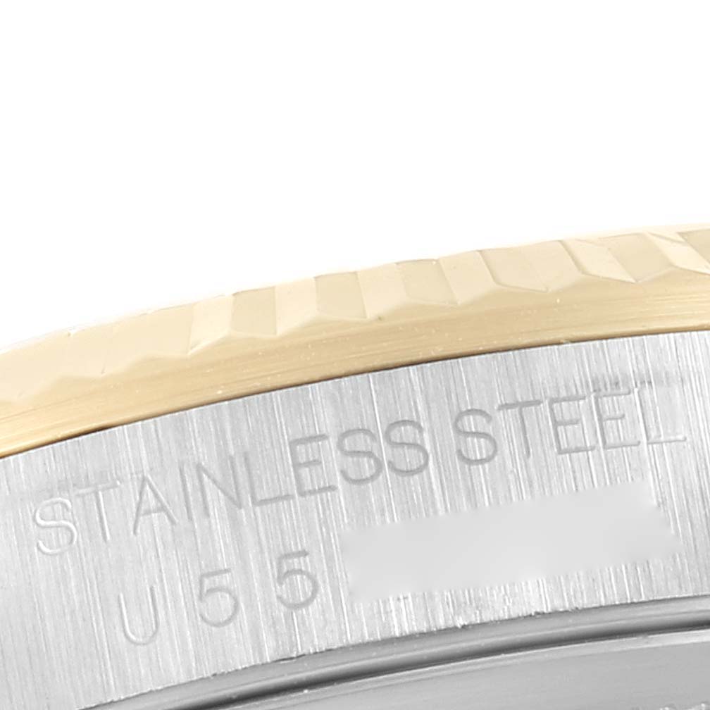 This close-up image shows the stainless steel and gold bezel of a Rolex Datejust 16233 Men's Steel and Gold (two tone) White Dial 16233 Men's Steel and Gold (two tone) White Dial watch.