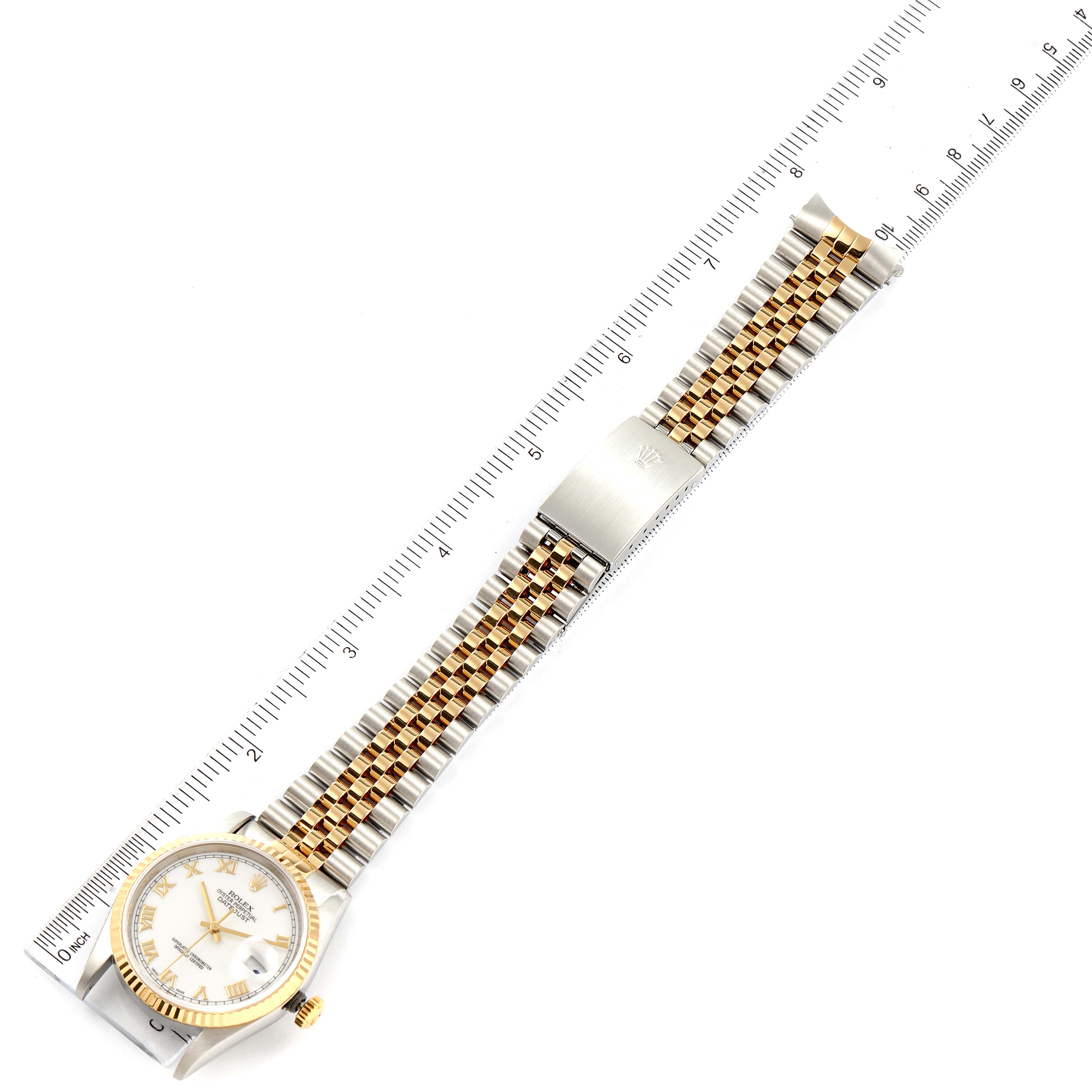 This image shows a top-down view of a Rolex Datejust 16233 Men's Steel and Gold (two tone) White Dial 16233 Men's Steel and Gold (two tone) White Dial watch, including the face, bracelet, and clasp, with a ruler for scale.