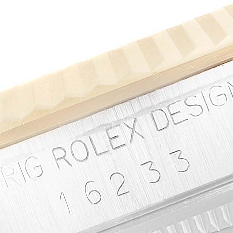 This close-up angle shows the serial number and part of the bezel on a Rolex Datejust 16233 Men's Steel and Gold (two tone) White Dial 16233 Men's Steel and Gold (two tone) White Dial watch.