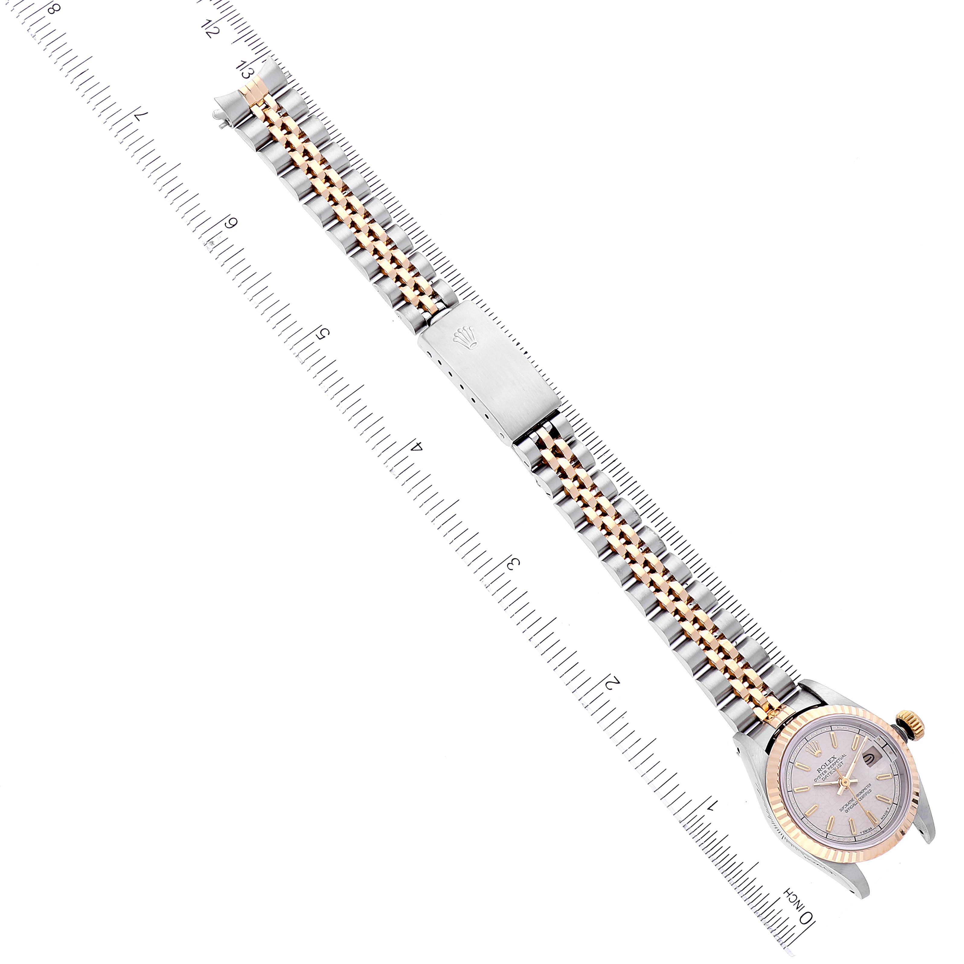 The image shows a Rolex Datejust 69173 Women's Steel and Gold (two tone) Silver Dial 69173 Women's Steel and Gold (two tone) Silver Dial watch laid flat with its bracelet and clasp visible, next to a ruler for scale.