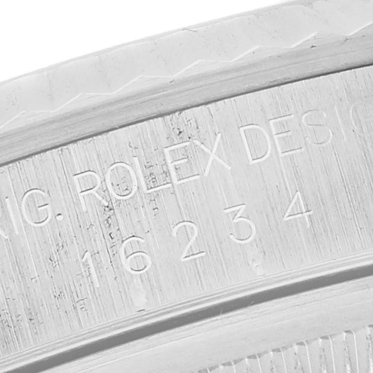 This close-up shot displays the engraved serial and model numbers on the inner bezel of a Rolex Datejust 16234 Men's Stainless Steel Silver Dial 16234 Men's Stainless Steel Silver Dial watch.