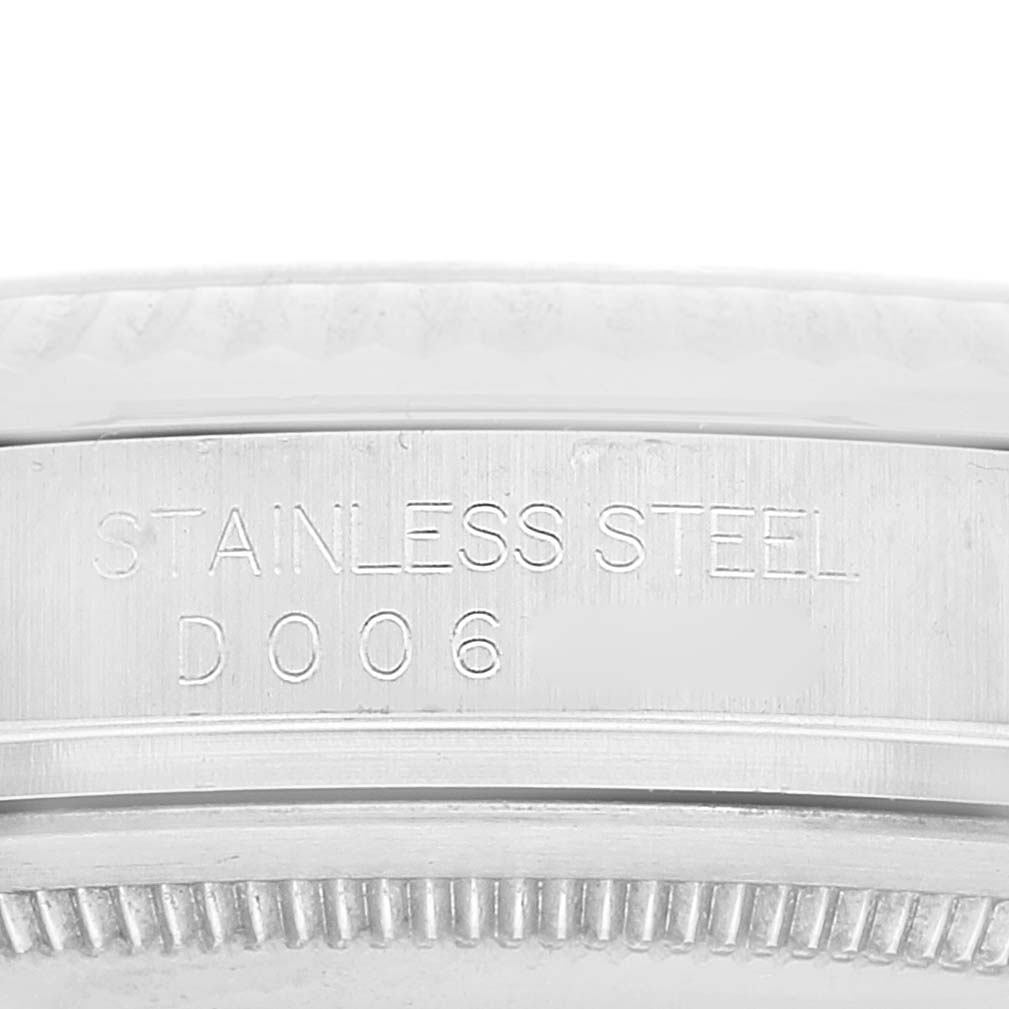 The image shows a close-up of the side of a Rolex Datejust 116234 Men's Stainless Steel Silver Dial 116234 Men's Stainless Steel Silver Dial model, highlighting the engraving on its stainless steel case.